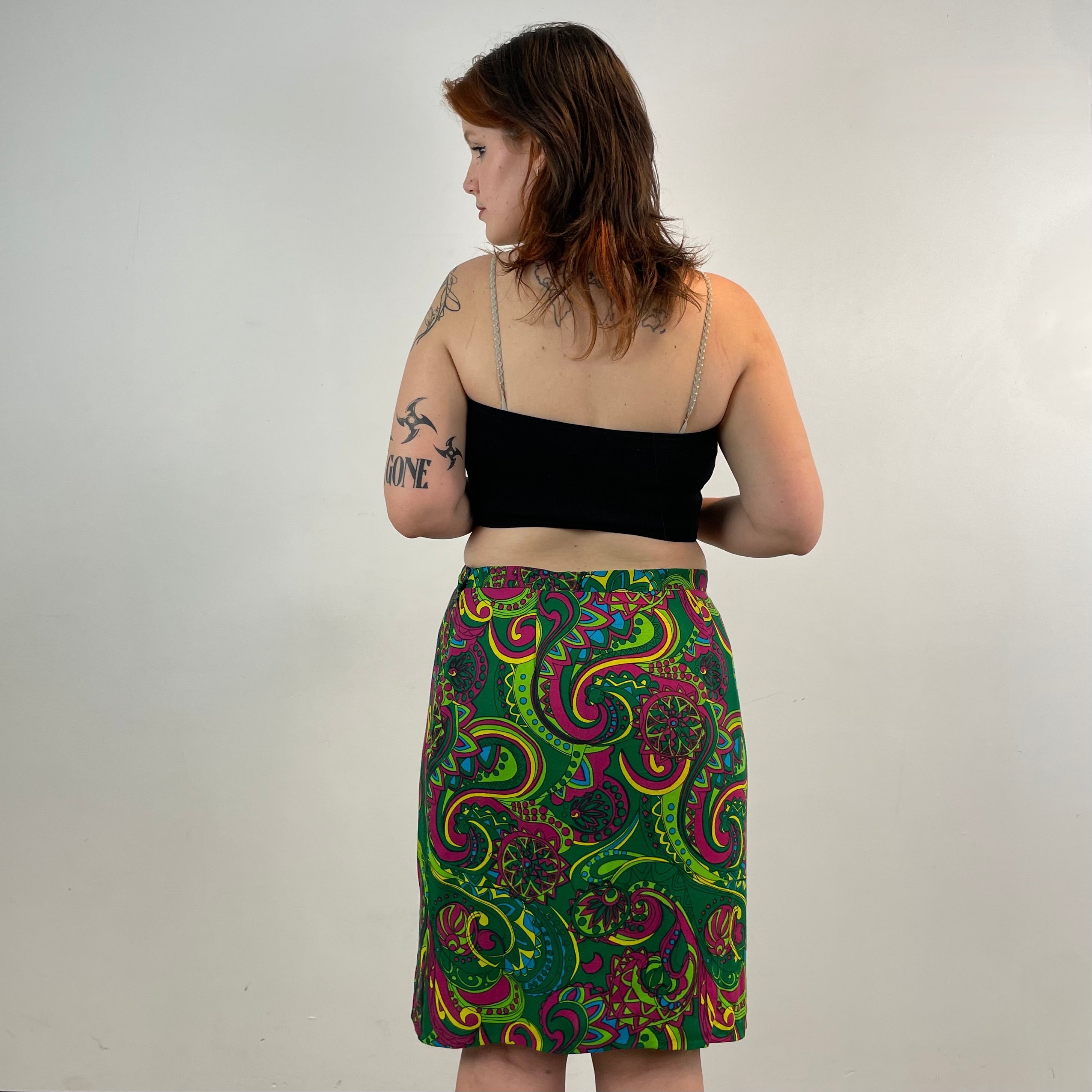 Vintage 1960s handmade skirt with a bold colorful psychedelic paisley print, straight cut, fitted hips, acetate lining and side metal zipper.