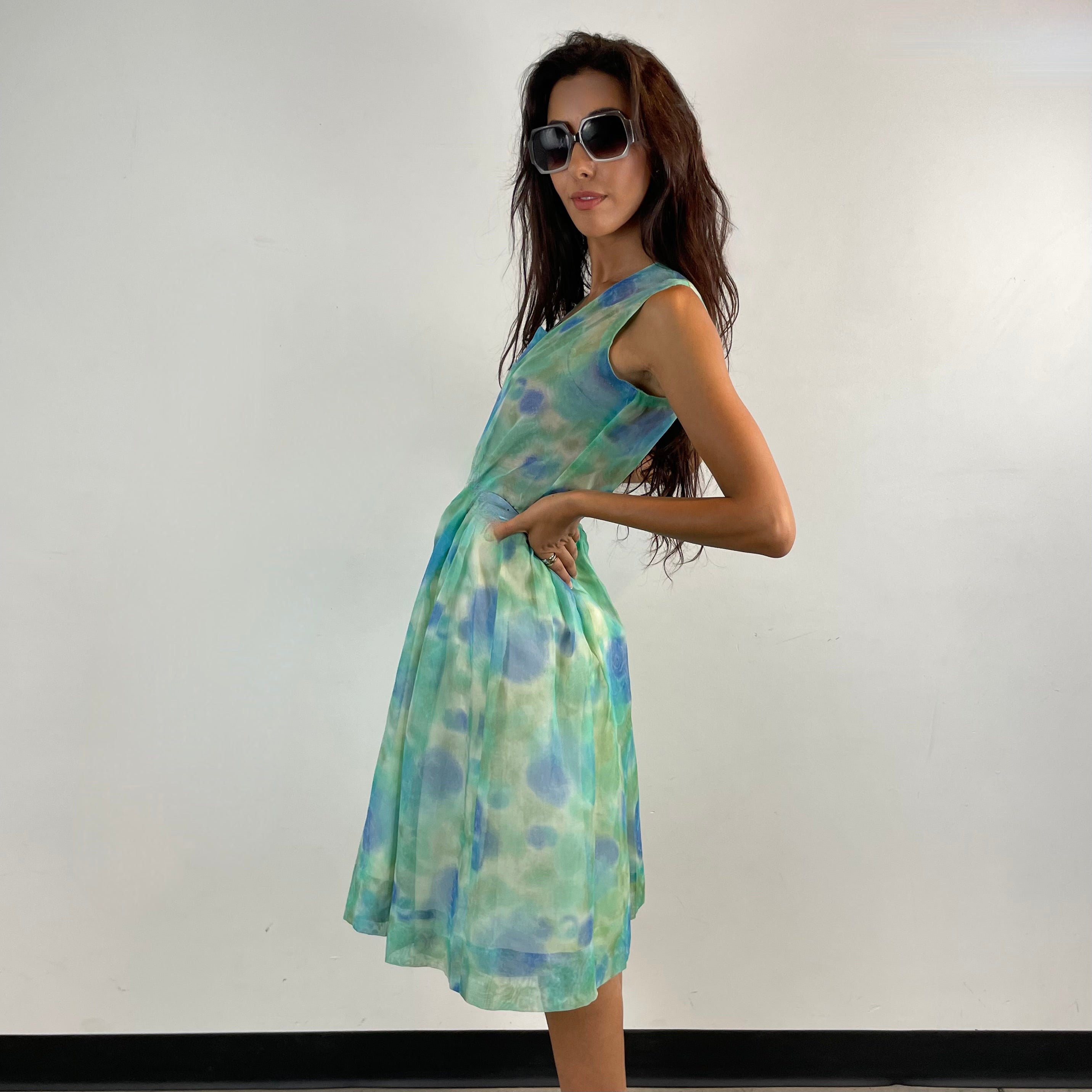 Side View of Boheme Vintage 1960s handmade floral culotte dress with sheer organza fabric, pleated wide-leg culottes, and cache-coeur neckline.