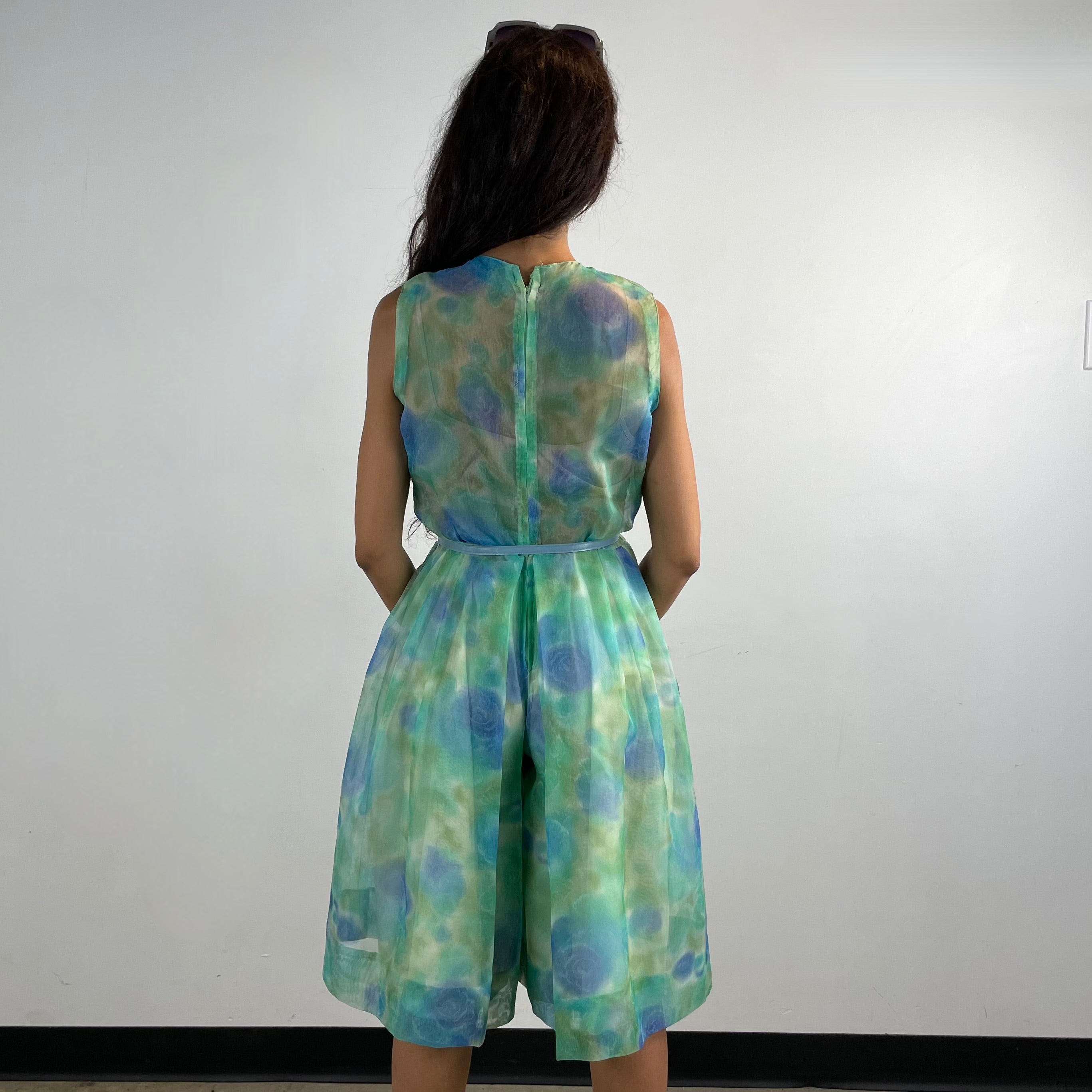 Back View of Boheme Vintage 1960s handmade floral culotte dress with sheer organza fabric, pleated wide-leg culottes, and cache-coeur neckline.