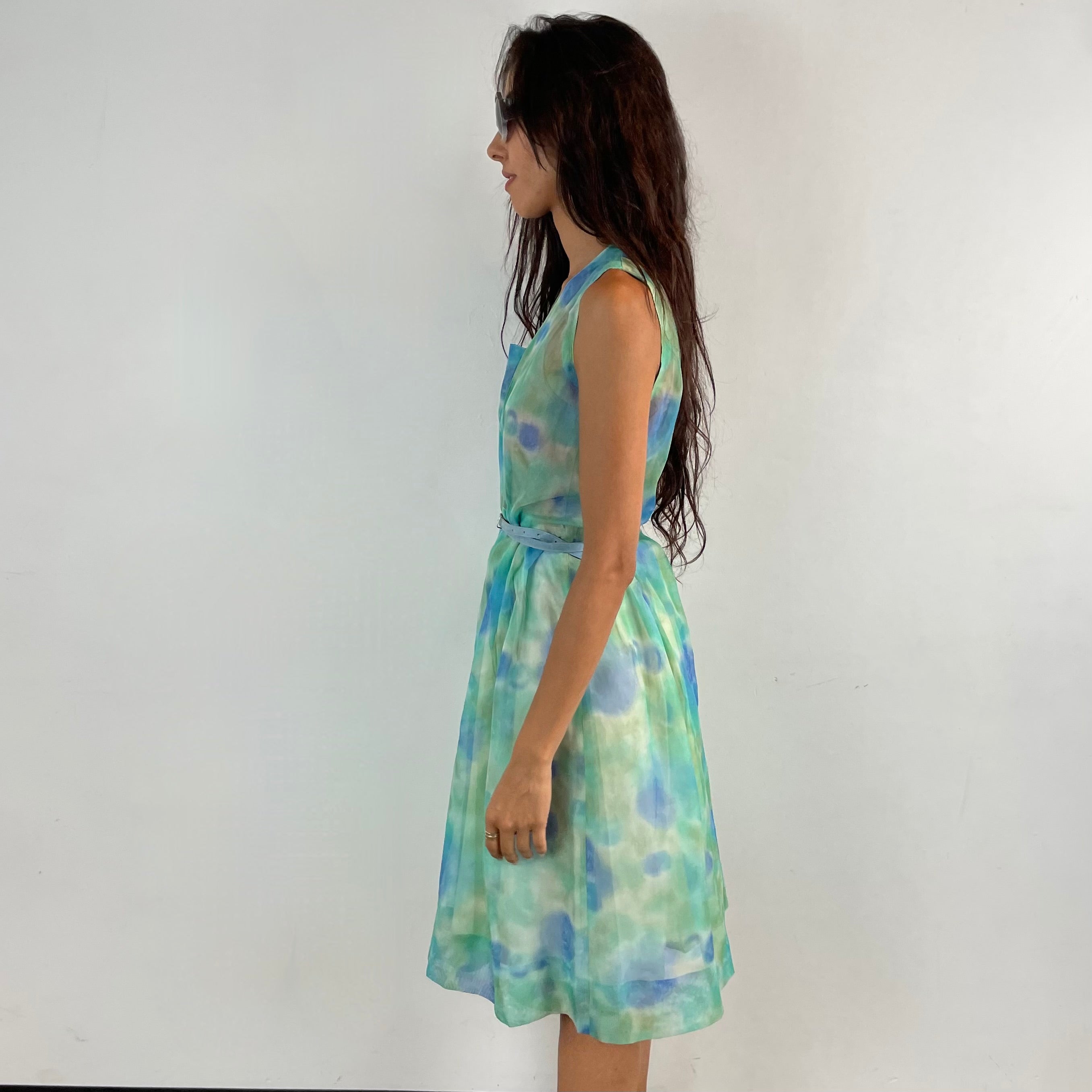 Side View of Boheme Vintage 1960s handmade floral culotte dress with sheer organza fabric, pleated wide-leg culottes, and cache-coeur neckline.