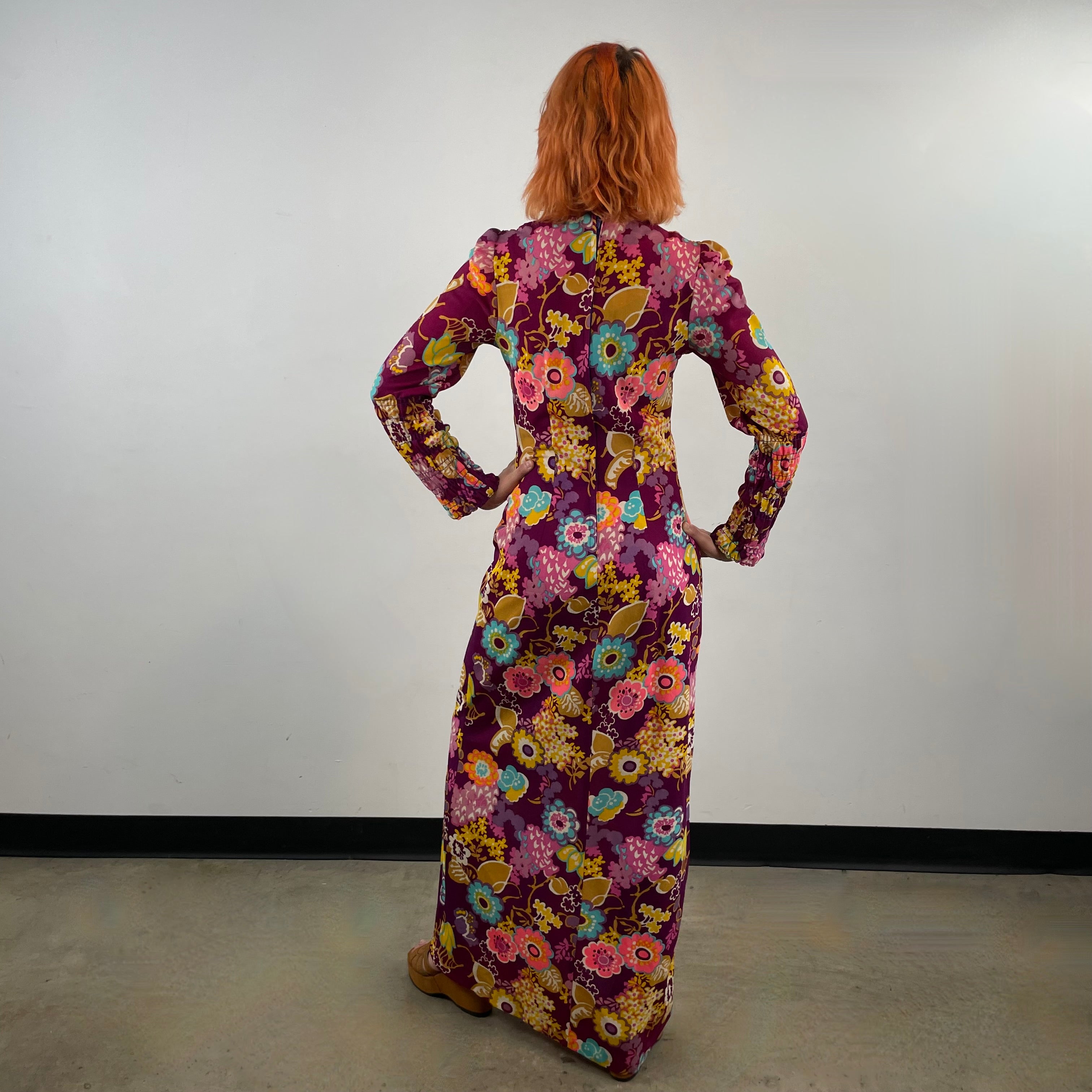 Back view of 1970s floral empire waist maxi dress with ruched bodice, high neckline and long ruched sleeves in bold print lightweight fabric – Boheme Vintage Montreal https://bohemevintage.com