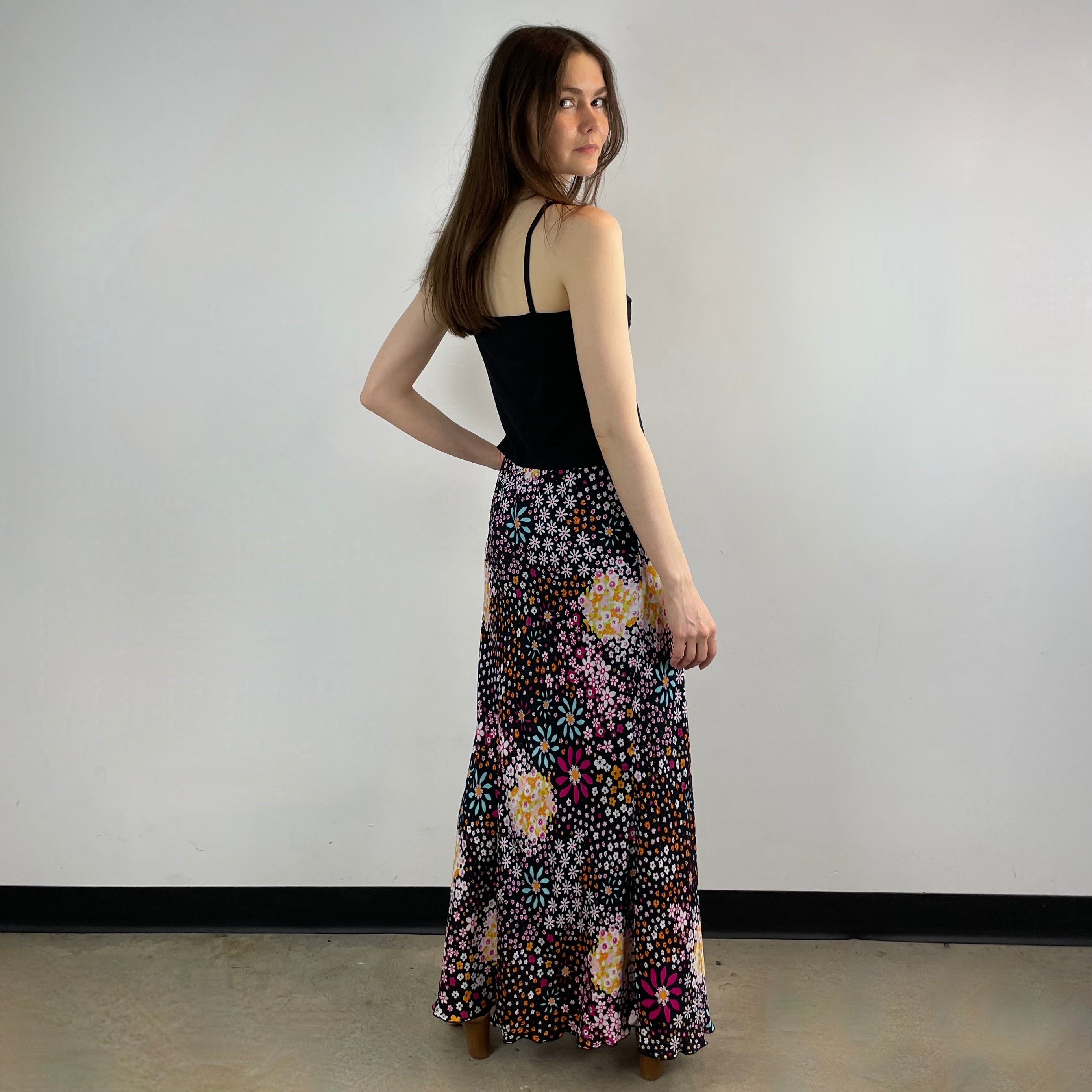 Vintage 1970s Ana Sanchez flared maxi skirt in dark colorful retro print, made from 100% viscose with an elastic waistband and knee-length lining.