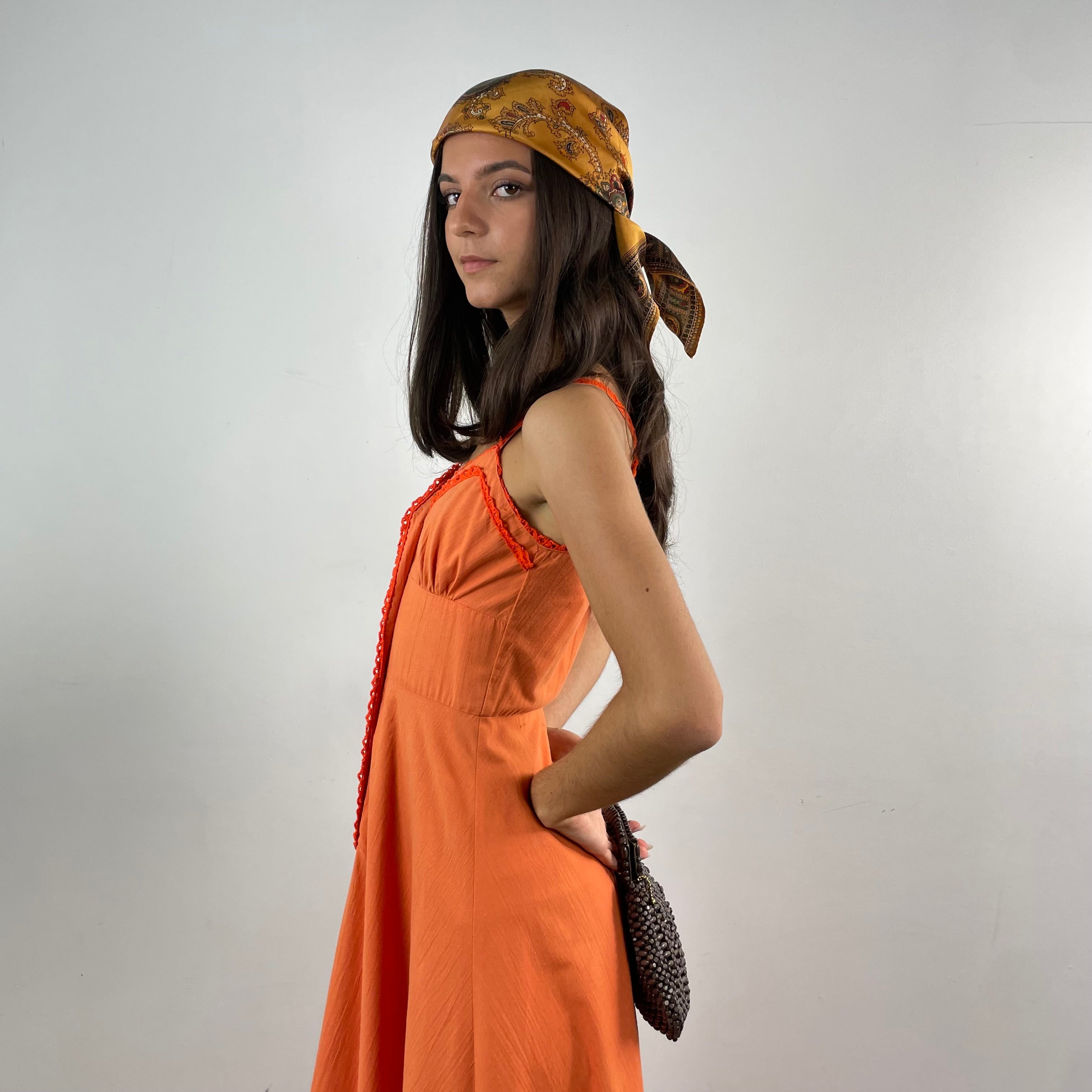 Boheme Vintage 1970s orange cotton empire waist maxi dress with crochet trim, front buttons, flared skirt, and patch pocket.