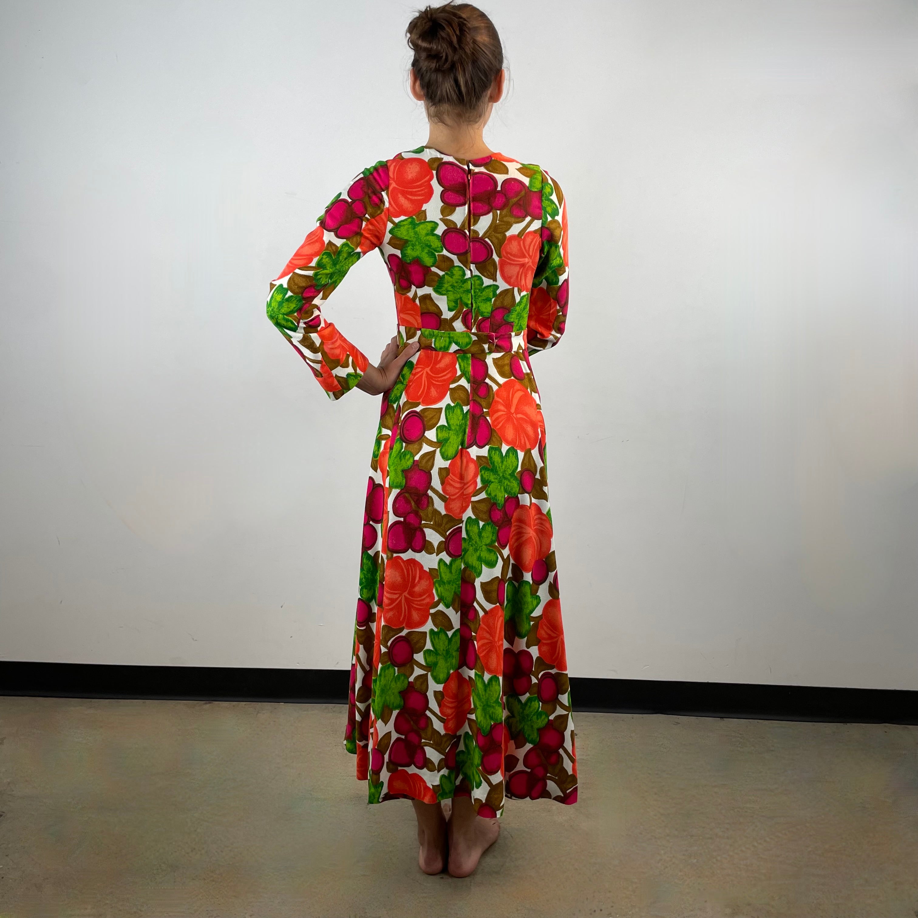 Vintage 1970s handmade long-sleeve dress in textured canvas-style fabric with bold artistic designs, fitted bodice, flared skirt and matching belt.