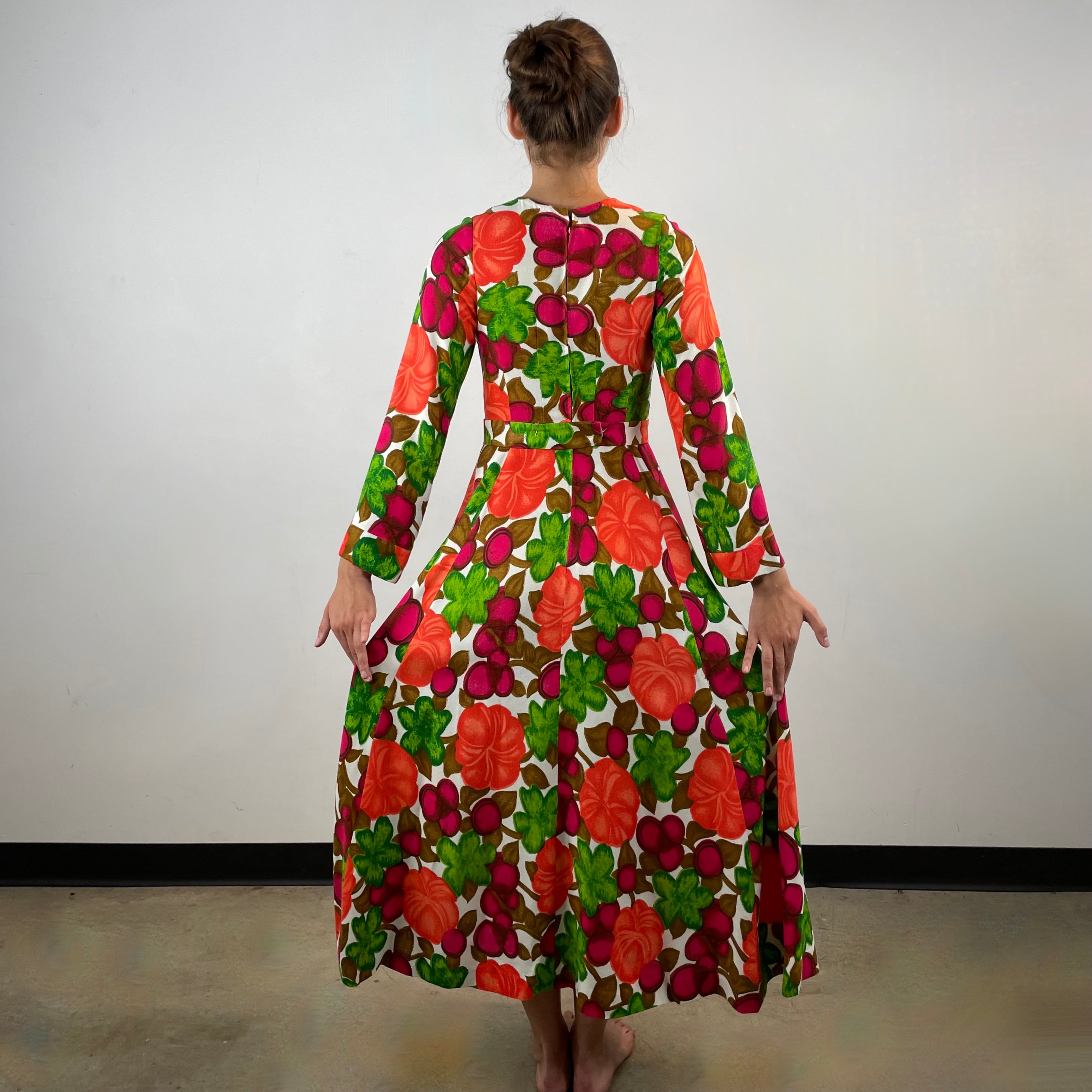 Vintage 1970s handmade long-sleeve dress in textured canvas-style fabric with bold artistic designs, fitted bodice, flared skirt and matching belt.