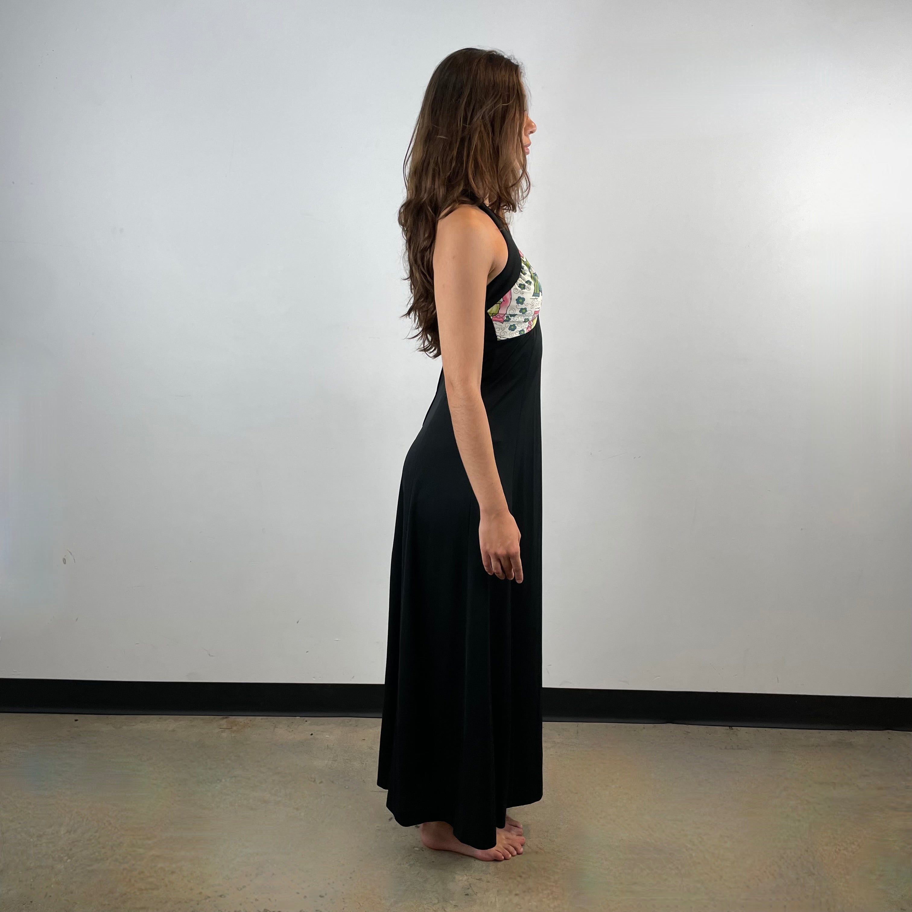 Side View of Boheme Vintage 1970s handmade black halter maxi dress with empire waist and patterned bust.
