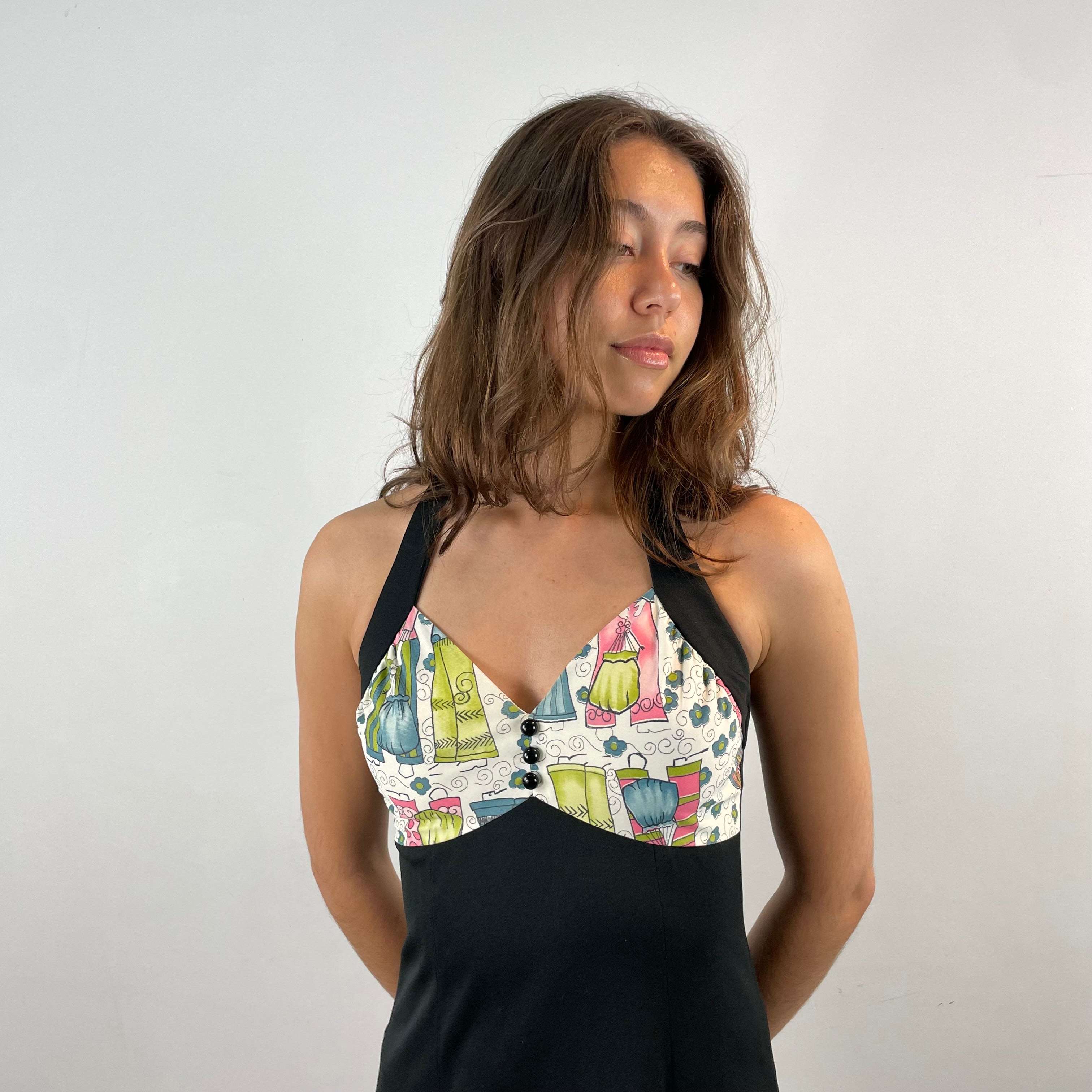 Close Up Front View of Boheme Vintage 1970s handmade black halter maxi dress with empire waist and patterned bust.