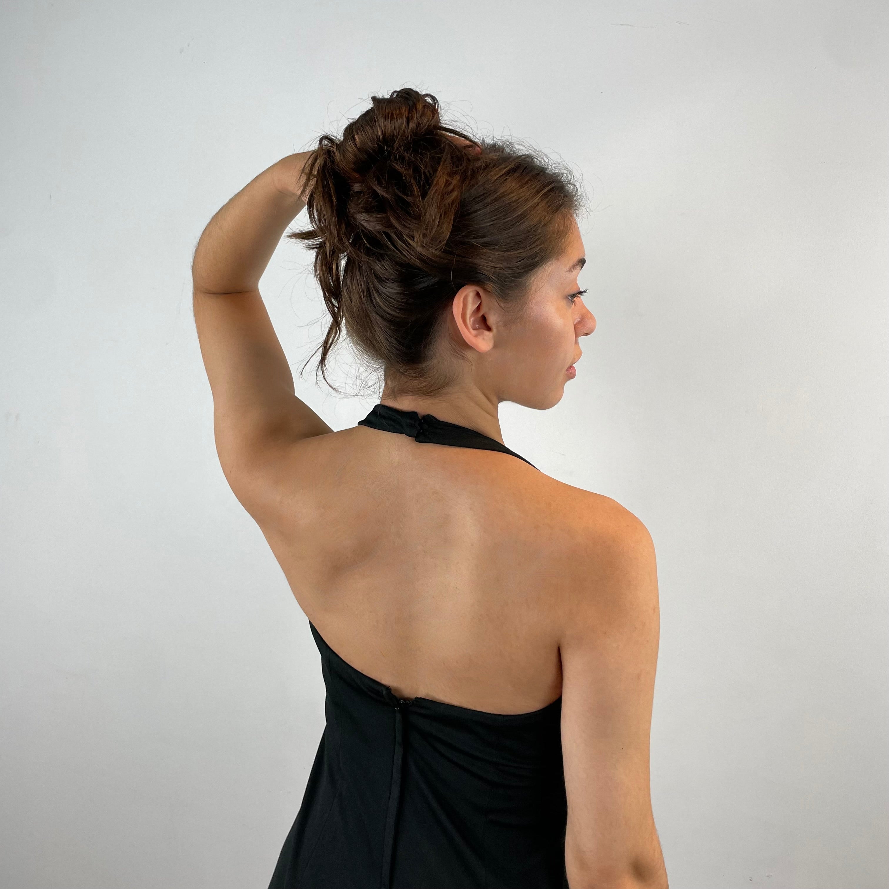 Close Up Back View of Boheme Vintage 1970s handmade black halter maxi dress with empire waist and patterned bust.