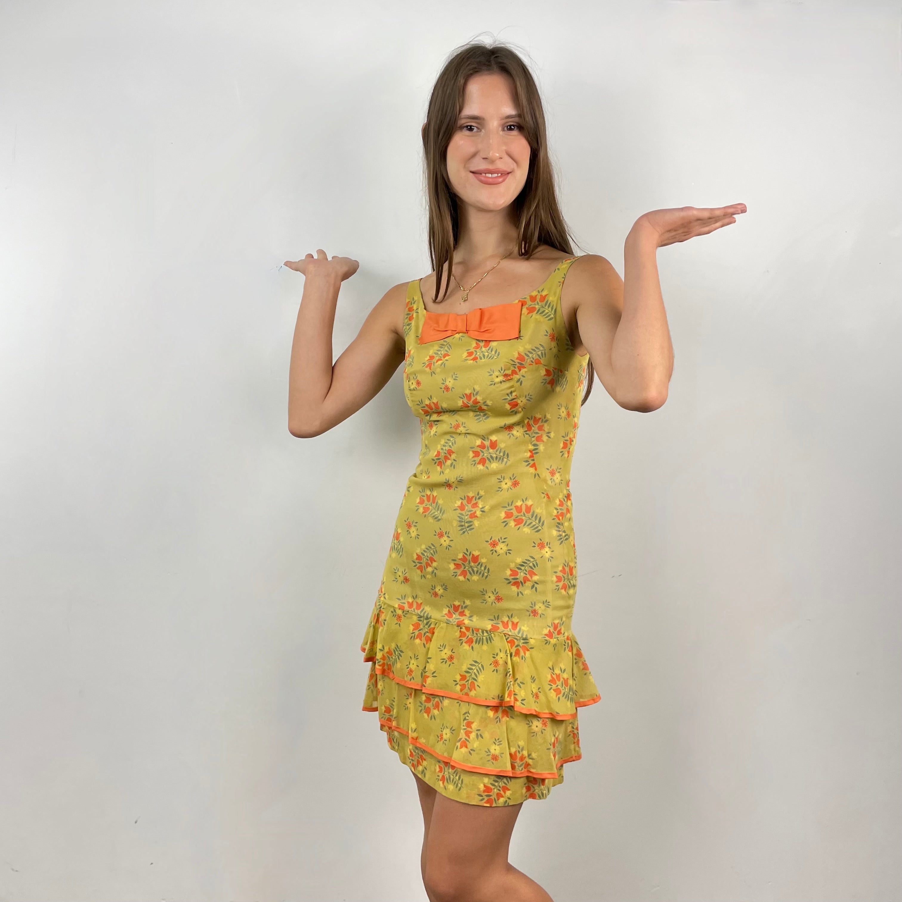 Boheme Vintage 1970s handmade sheath dress with scoop neckline, bow detail, and flounced hem.