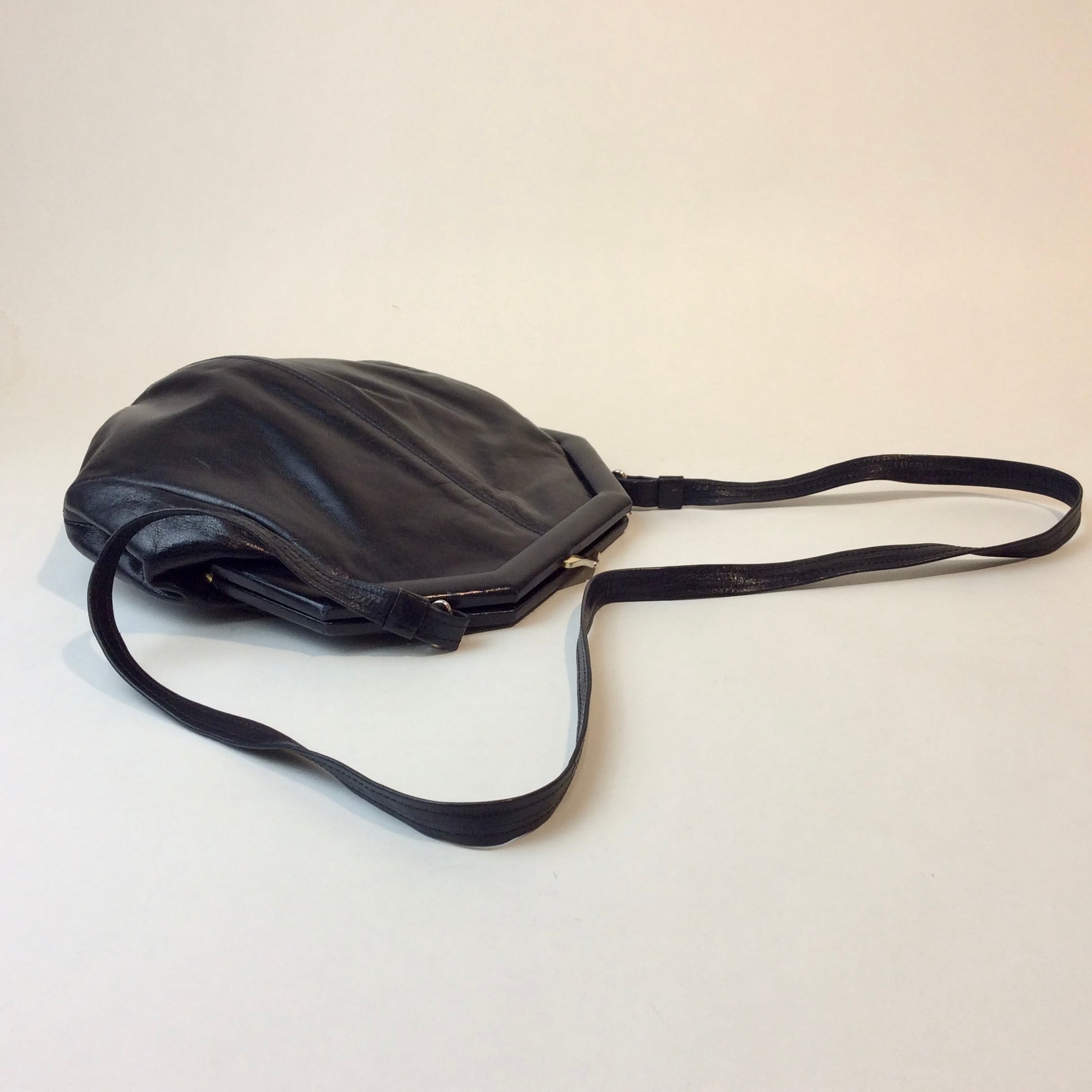 1980s Bruno Magli navy leather handbag with octagonal shape and gold push-lock closure, styled for shoulder or crossbody at Boheme Vintage in Montreal — bohemevintage.com