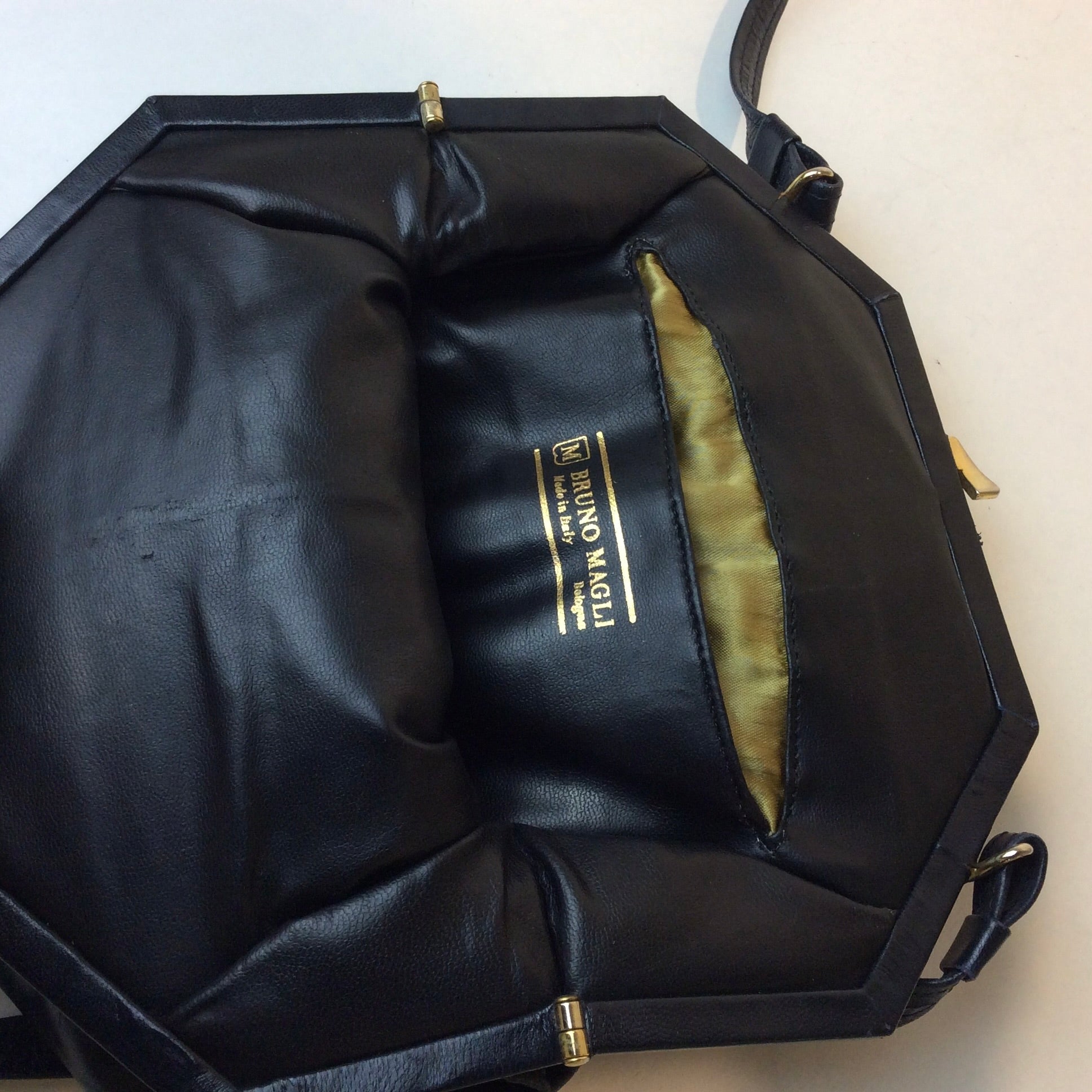 1980s Bruno Magli navy leather handbag with octagonal shape and gold push-lock closure, styled for shoulder or crossbody at Boheme Vintage in Montreal — bohemevintage.com