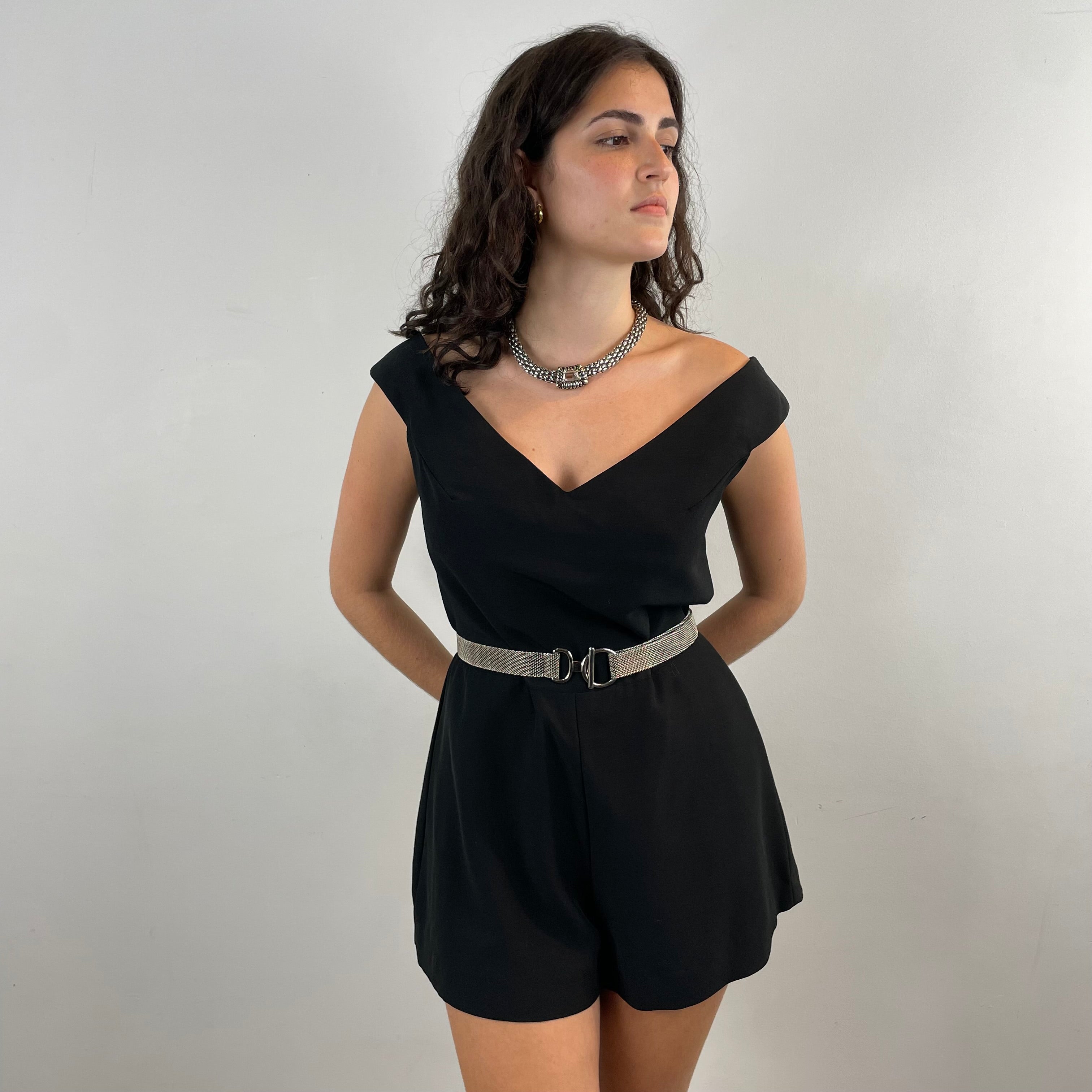 Front View of Boheme Vintage 1980s C’est Ma Mère Qui M’habille black romper with deep V neckline and flared shorts.