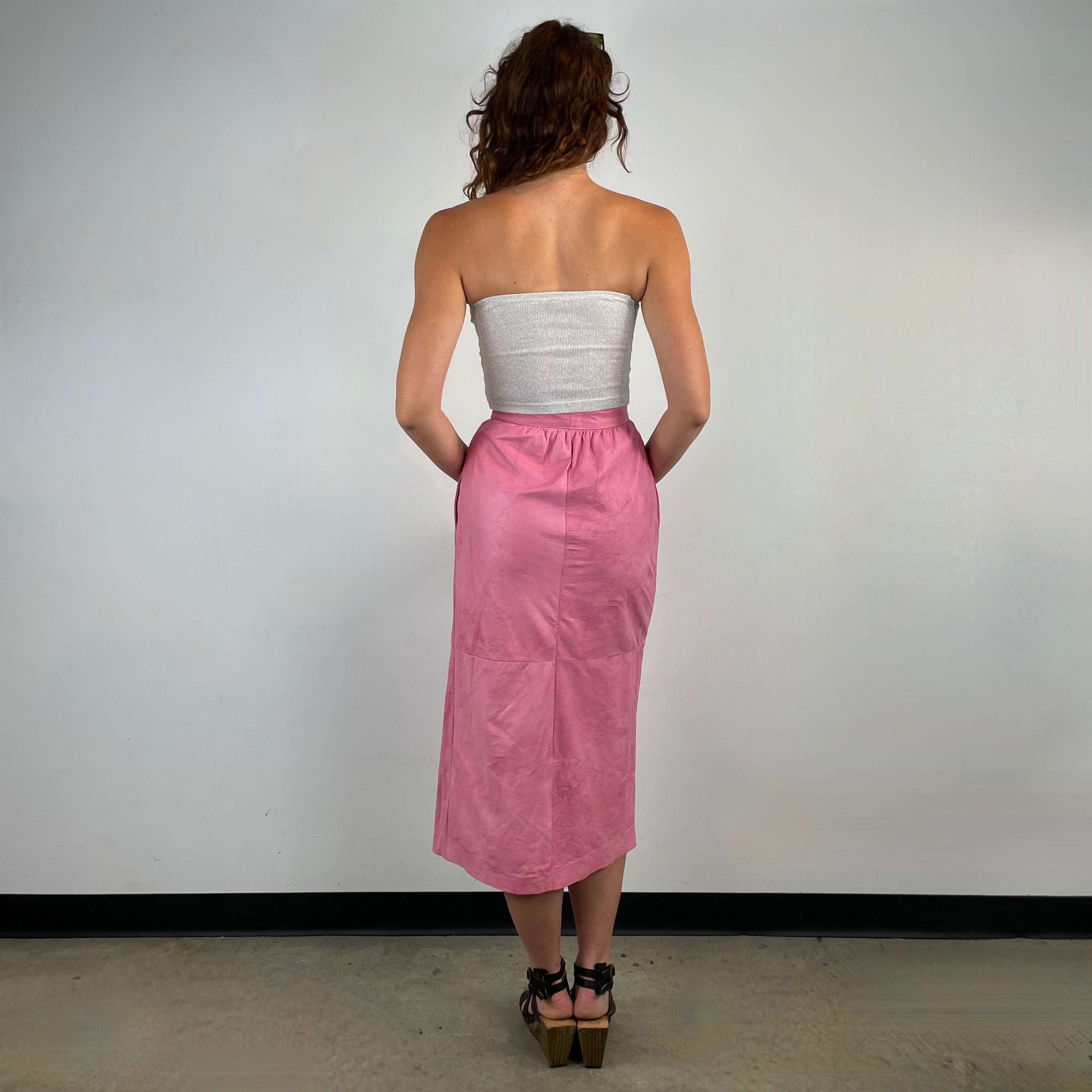 Back view of 1980s Robert Krief Designer Pink Leather Midi Skirt 
Size Small/Medium
Sold at bohemevintage.com 
Montréal 