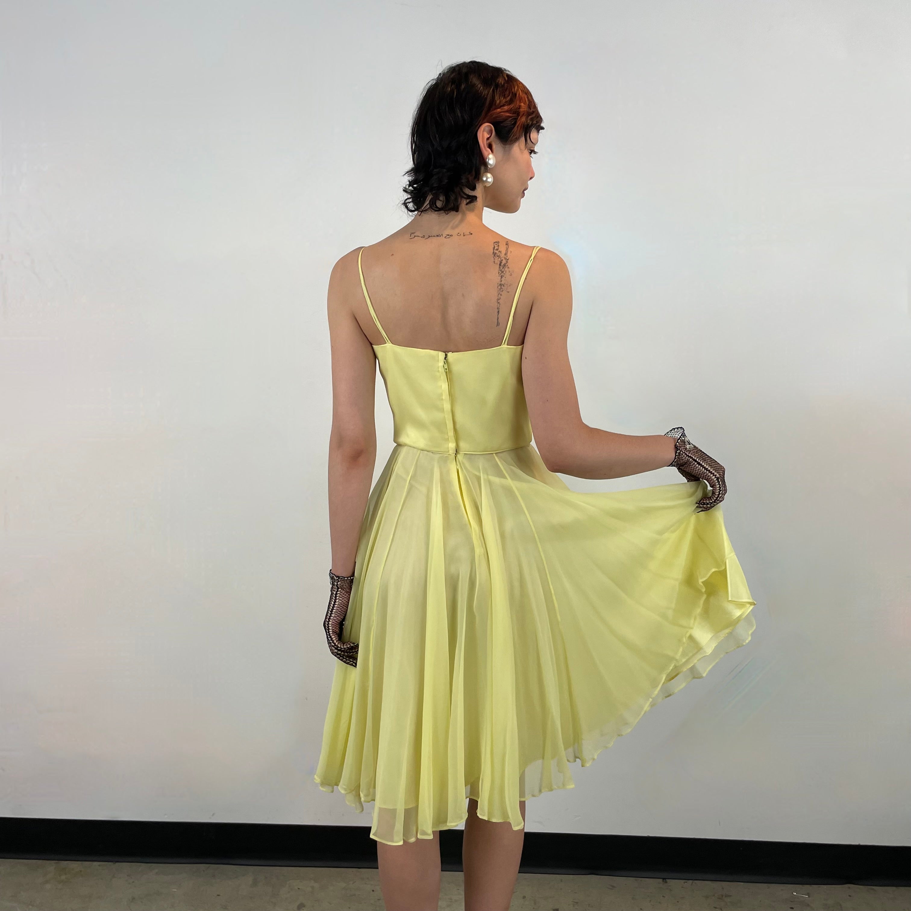Back view of 1960s Yellow Chiffon Cocktail Dress 
size Small
sold at bohemevintage.com 
Montréal