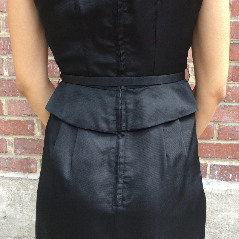 Close up back view of 1950s Black Dress With Peplum 
Size Extra-Small/Small 
Sold at bohemevintage.com
Montréal