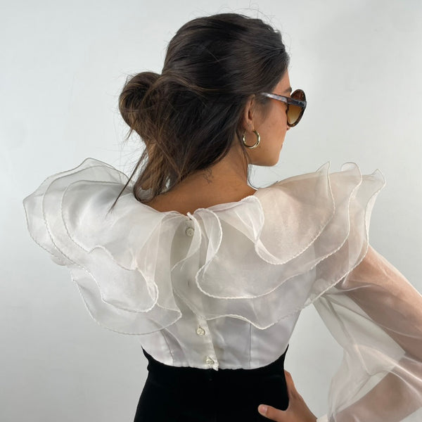 Close up back view of 1980s Ruffle Collar Stirrup Jumpsuit
Size Small
Sold at bohemevintage.com Montréal 