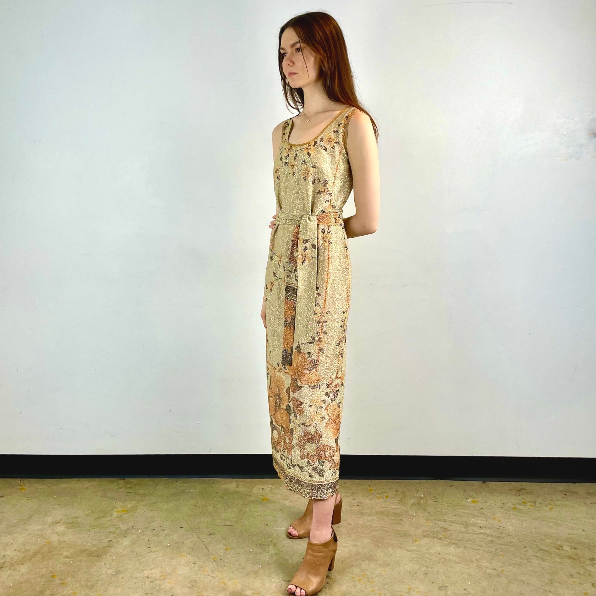 Boheme Vintage 1970s Le Petit Salon Dupuis gold Lurex maxi dress with sheer brocade fabric, sleeveless silhouette, and belt.
