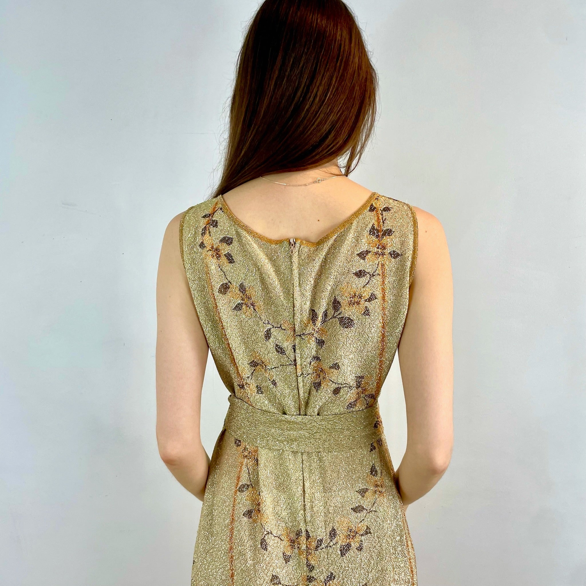 Boheme Vintage 1970s Le Petit Salon Dupuis gold Lurex maxi dress with sheer brocade fabric, sleeveless silhouette, and belt.