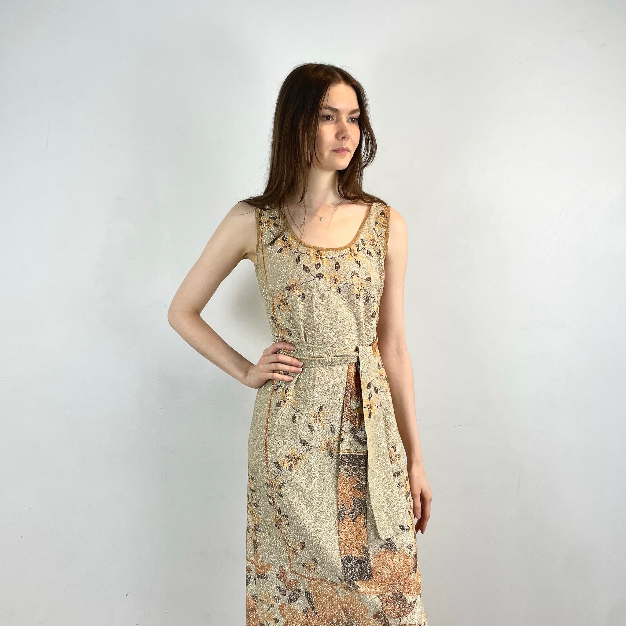 Boheme Vintage 1970s Le Petit Salon Dupuis gold Lurex maxi dress with sheer brocade fabric, sleeveless silhouette, and belt.