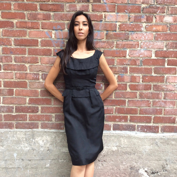 front view of 1950s Black Dress With Peplum 
Size Extra-Small/Small 
Sold at bohemevintage.com
Montréal