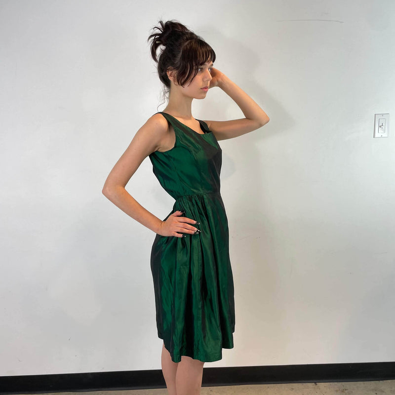 Side view of 1950s Green Metallic Petite Dress Size small to extra small sold at bohemevintage.com Montreal