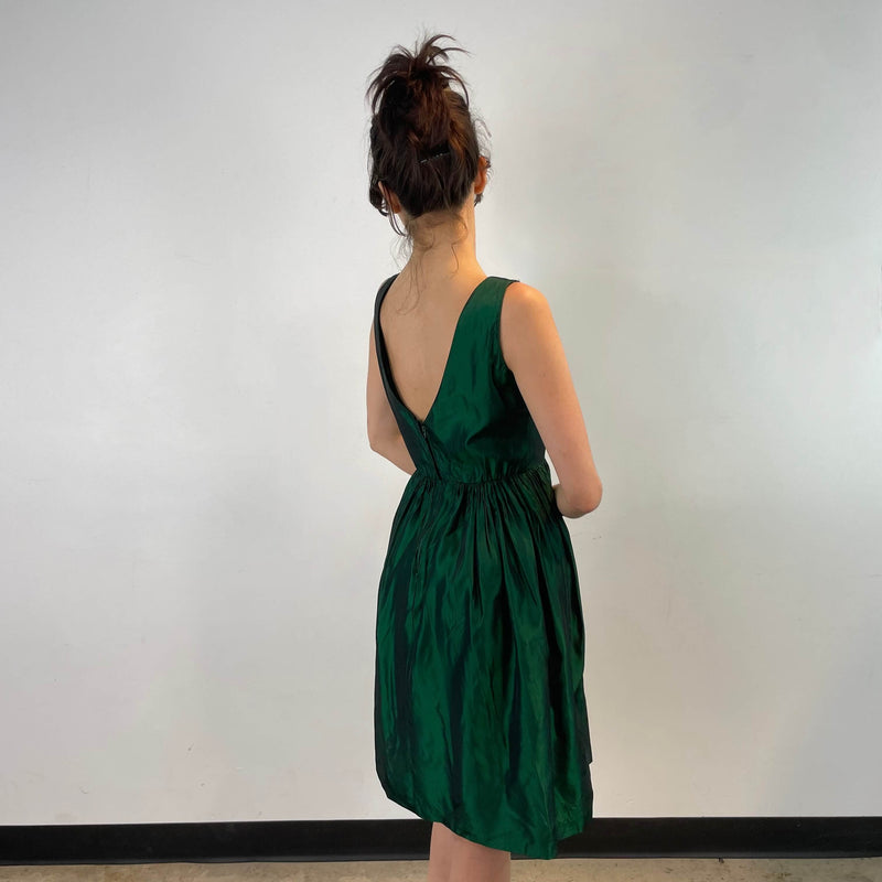 Side and back view of 1950s Green Metallic Petite Dress Size small to extra small sold at bohemevintage.com Montreal