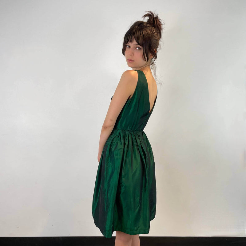 Side view of 1950s Green Metallic Petite Dress Size small to extra small sold at bohemevintage.com Montreal