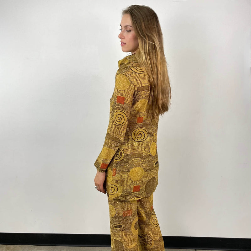 Side view of 1960s/70s Gold Patterned Mini Dress and Pant Set Size small sold at bohemevintage.com Montreal