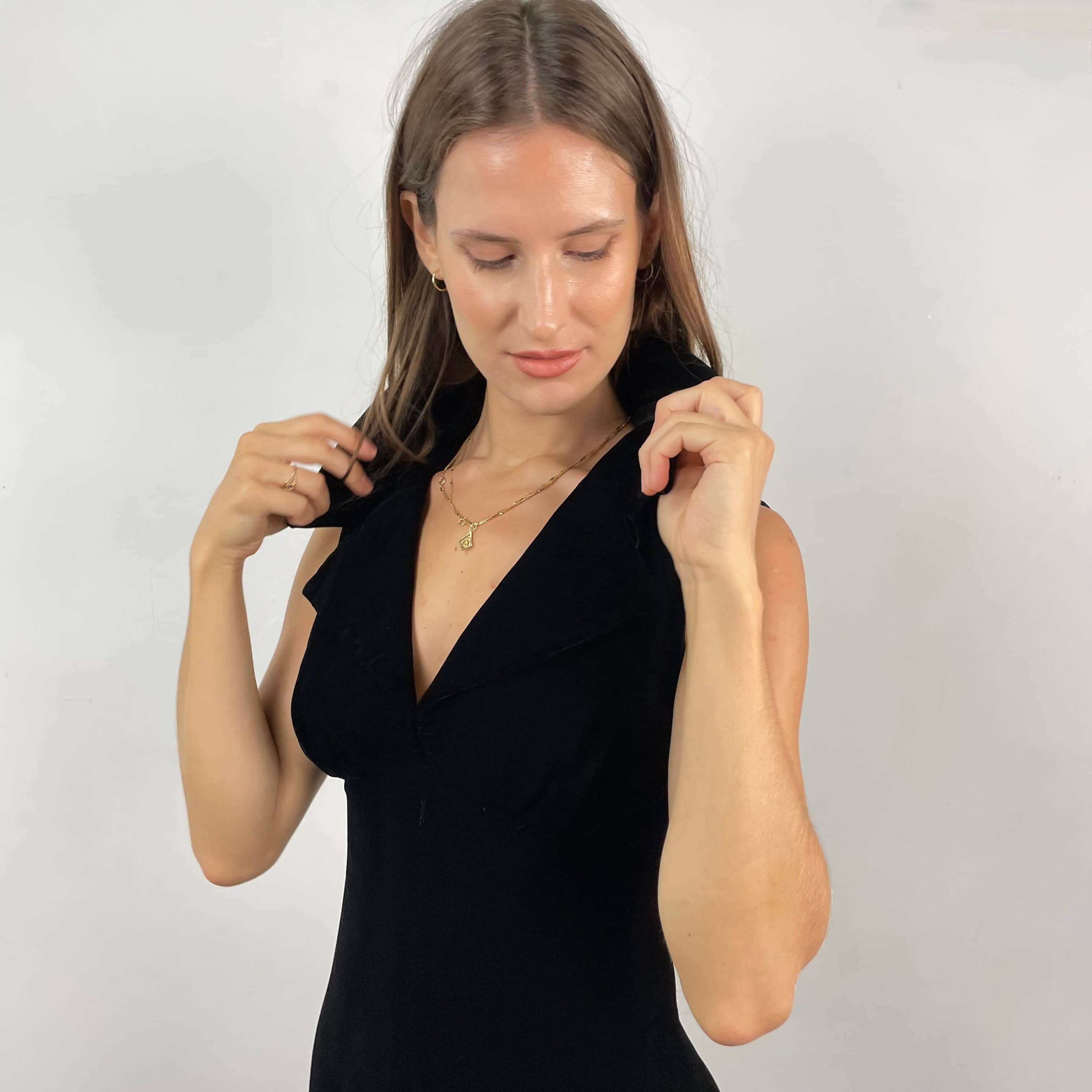  Close up view of plunging neckline of 1970s Deep V-Neck Black Velvet Midi Dress Size Small sold on bohemevintage.com Montreal