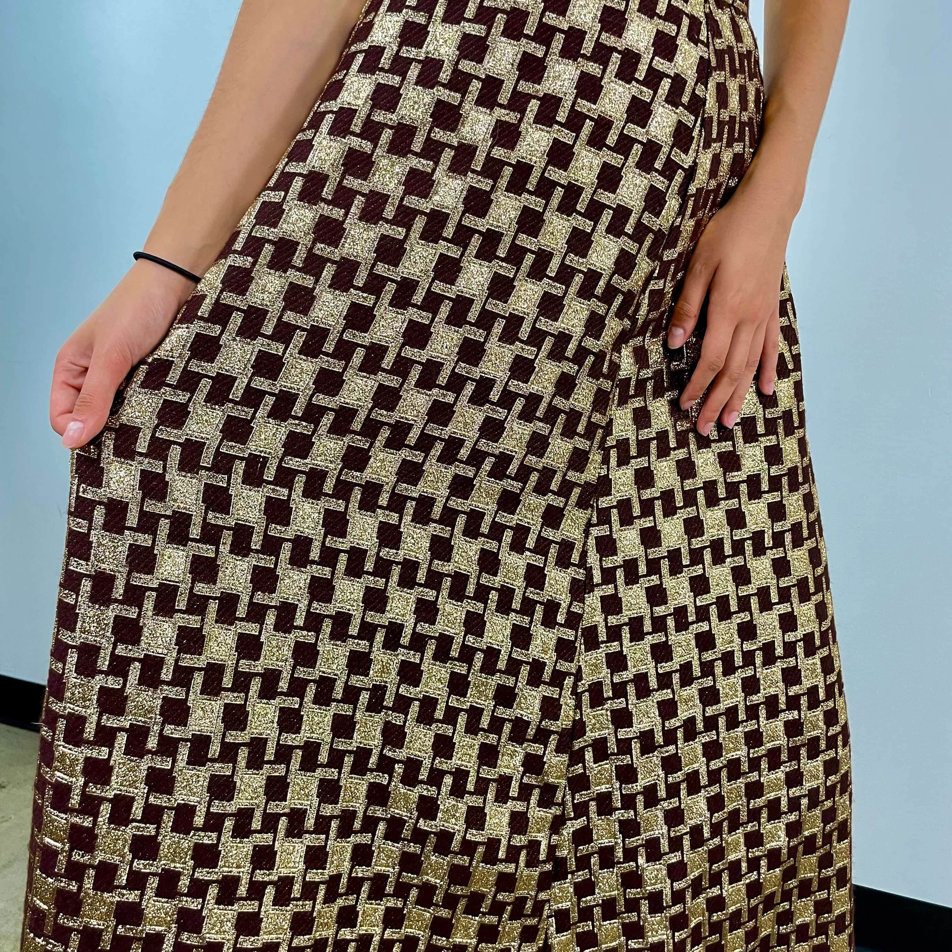 Close-up view of fabric of 1970s Gold Brocade Flared Maxi Skirt Size small / Medium sold at bohemevintage.com Montreal