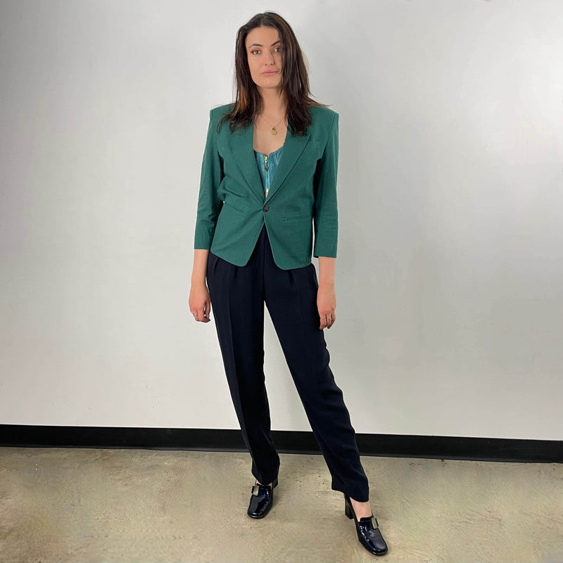 Front View of 1980s Christian Dior Green Cotton Blazer Size Small paired with a straight leg black trouser sold at bohemevintage.com Montreal