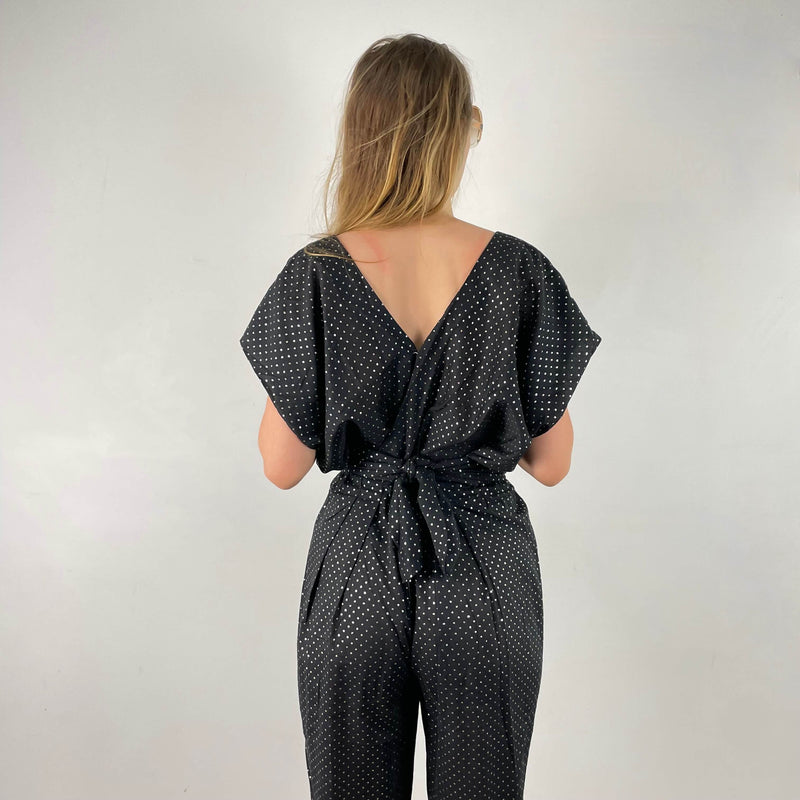 Close up view of back of 1980s Gold Dotted Black Jumpsuit Size Small-Medium sold at bohemevintage.com Montreal
