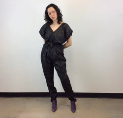 Front view of  1980s Gold Dotted Black Jumpsuit Size Small-Medium sold at bohemevintage.com Montreal