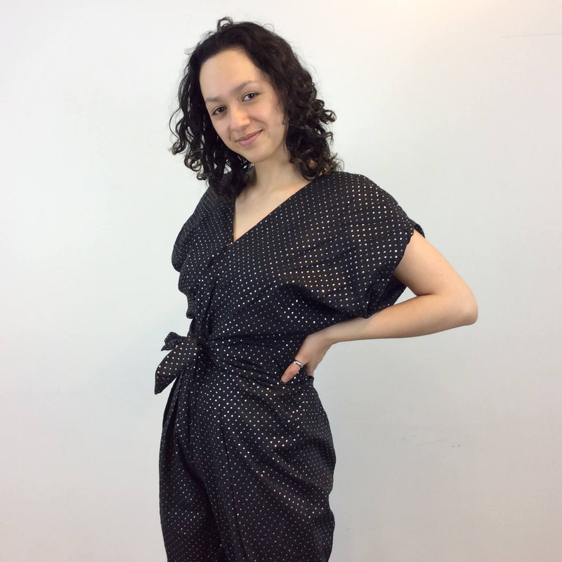 Close up view of front and side of 1980s Gold Dotted Black Jumpsuit Size Small-Medium sold at bohemevintage.com Montreal