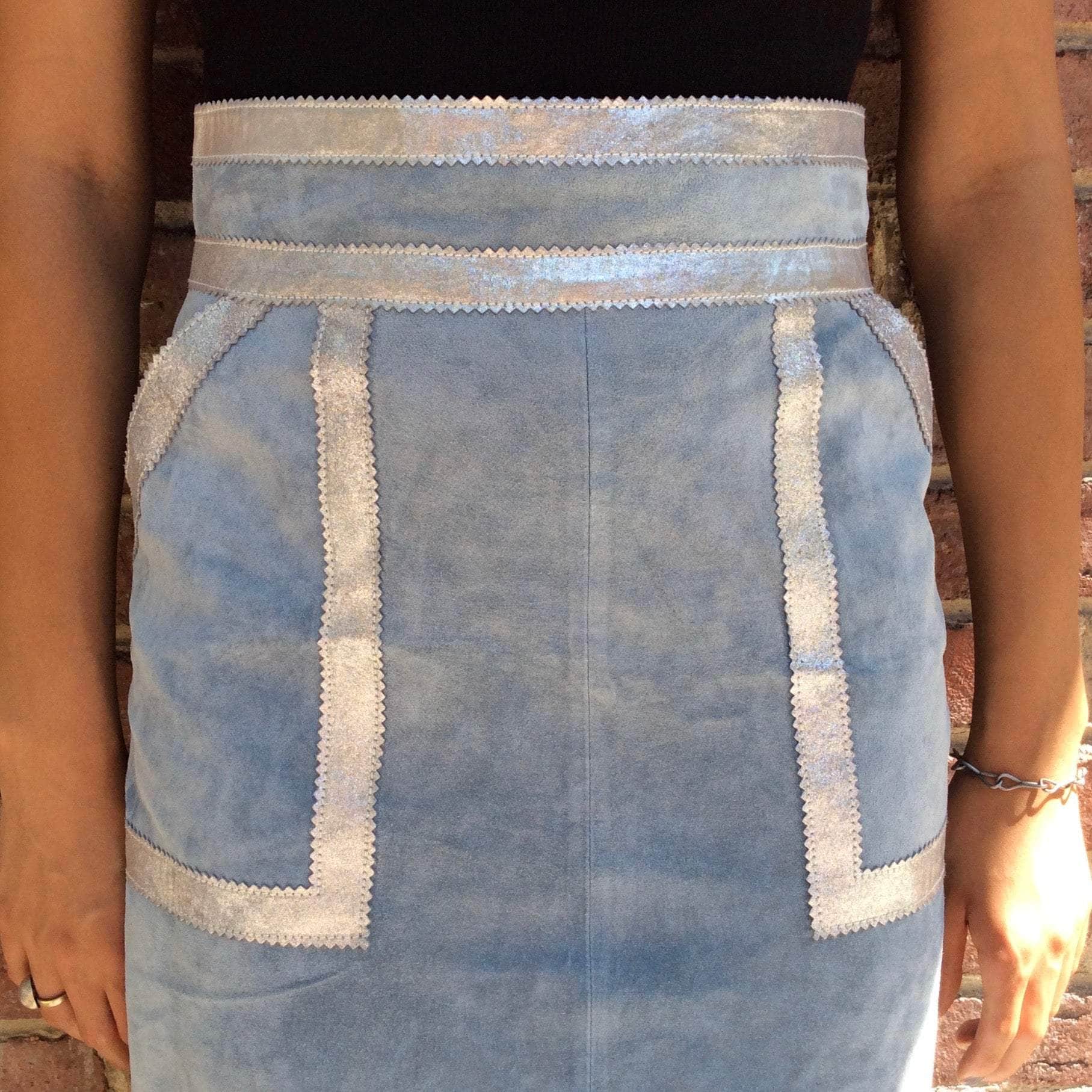 Close up view of Boheme Vintage 1990s Y2K baby blue suede midi skirt with silver leather trim and patch pockets.