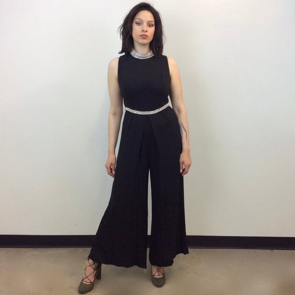 Front view of 1960s Wide Leg Black Evening Jumpsuit Size Medium sold at bohemevintage.com Montreal