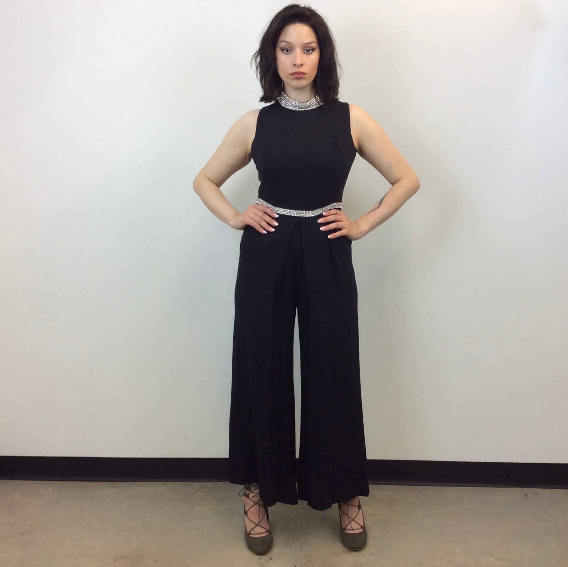  Front view of 1960s Wide Leg Black Evening Jumpsuit Size Medium sold at bohemevintage.com Montreal