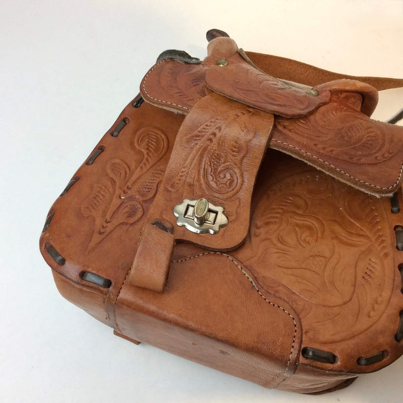 Close-up view of clasp of 1970's Saddle Tooled Leather Shoulder Bag sold at bohemevintage.com