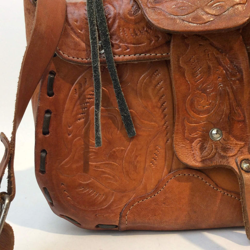 Close-up view of tooled design of 1970's Saddle Tooled Leather Shoulder Bag sold at bohemevintage.com