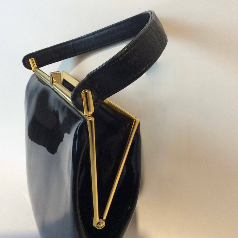 Side view of 1950s-60s Black Patent Leather Handbag with Decorative Buckle Strap sold at bohemevintage.com Montreal