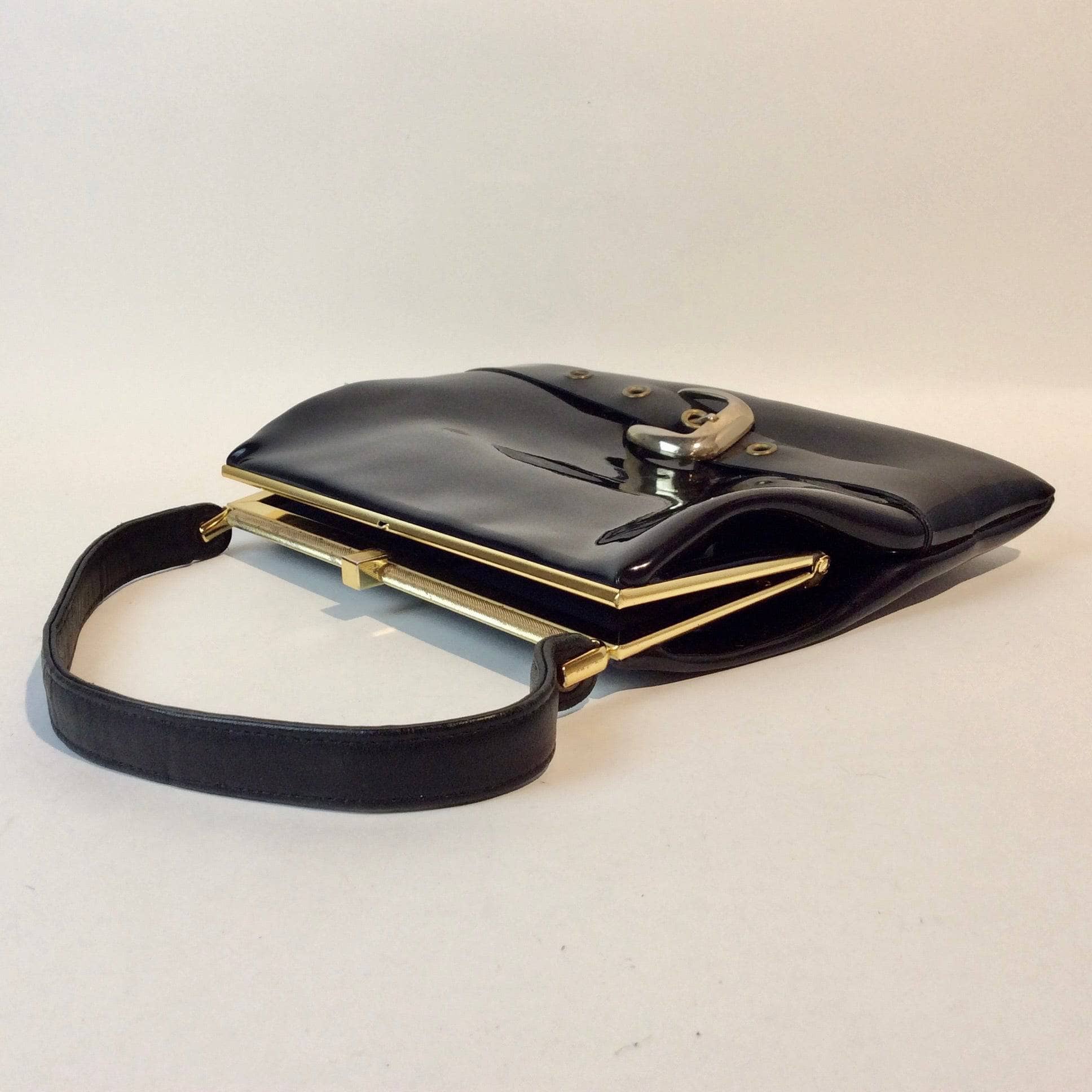 1950s-60s Black Patent Leather Handbag with Decorative Buckle Strap sold at bohemevintage.com Montreal