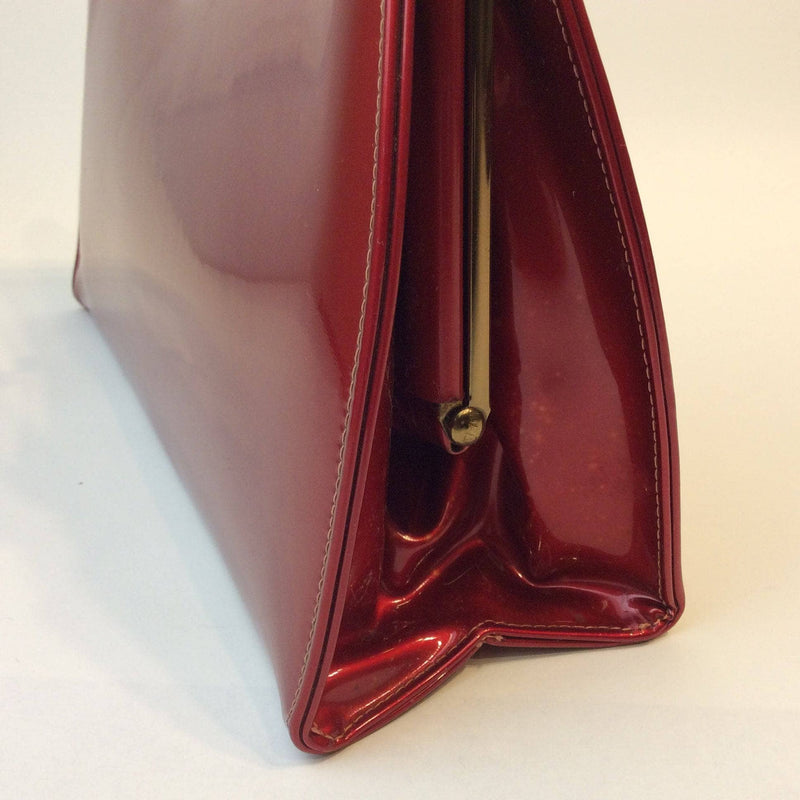Side View of 1950s Glossy Red Handbag sold by bohemevintage.com Montreal