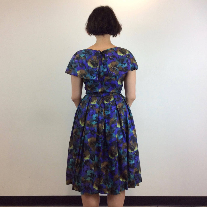 Back View of 1950s Purple Abstract Print Full Skirt , Fit and Flare Silk Dress, size Medium, sold at bohemevintage.com Montréal