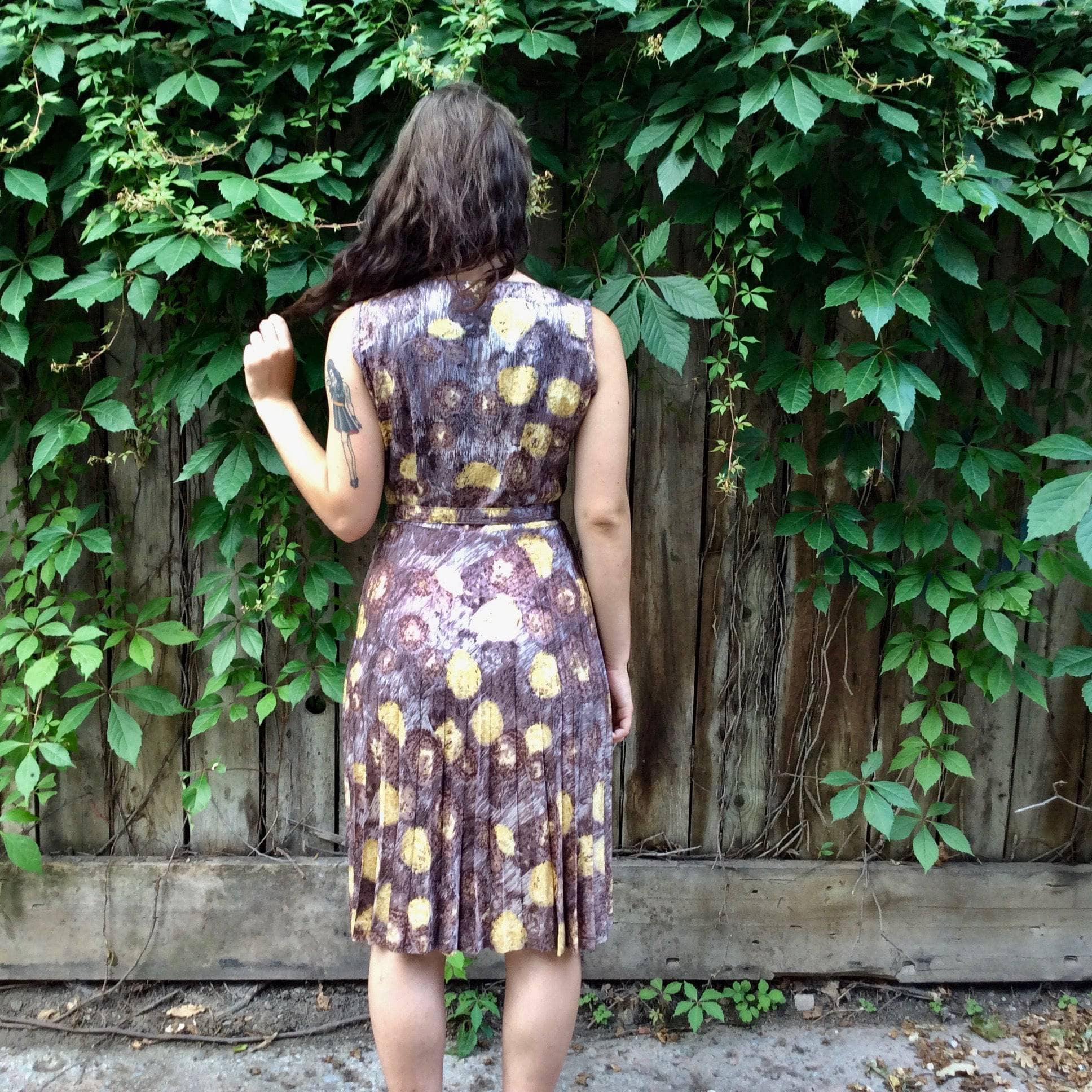 Back view of 1950s Sunburst Pleated Sleeveless Dress Size Medium sold by bohemevintage.com Montreal