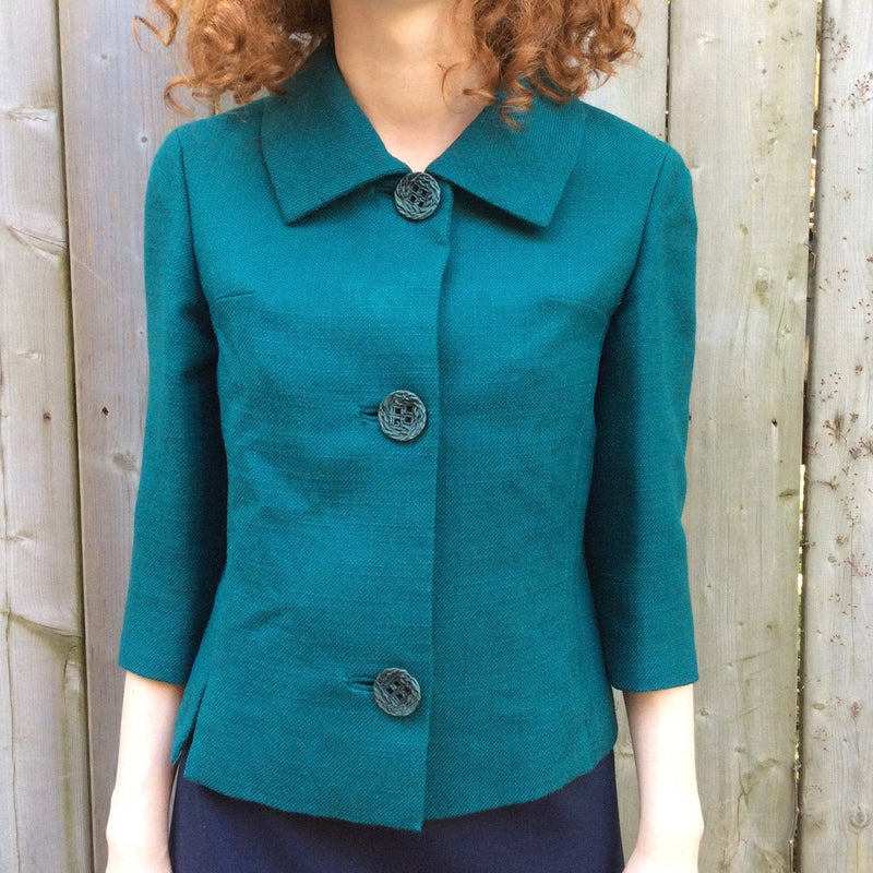 Close-up view of 1960s 3/4 Sleeve Teal Wool Blazer size small sold by bohemevintage.com Montréal