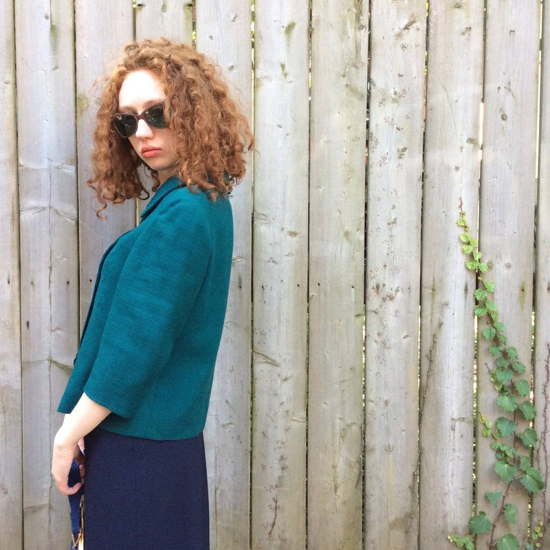 Side view of 1960s 3/4 Sleeve Teal Wool Blazer size small sold by bohemevintage.com Montréal