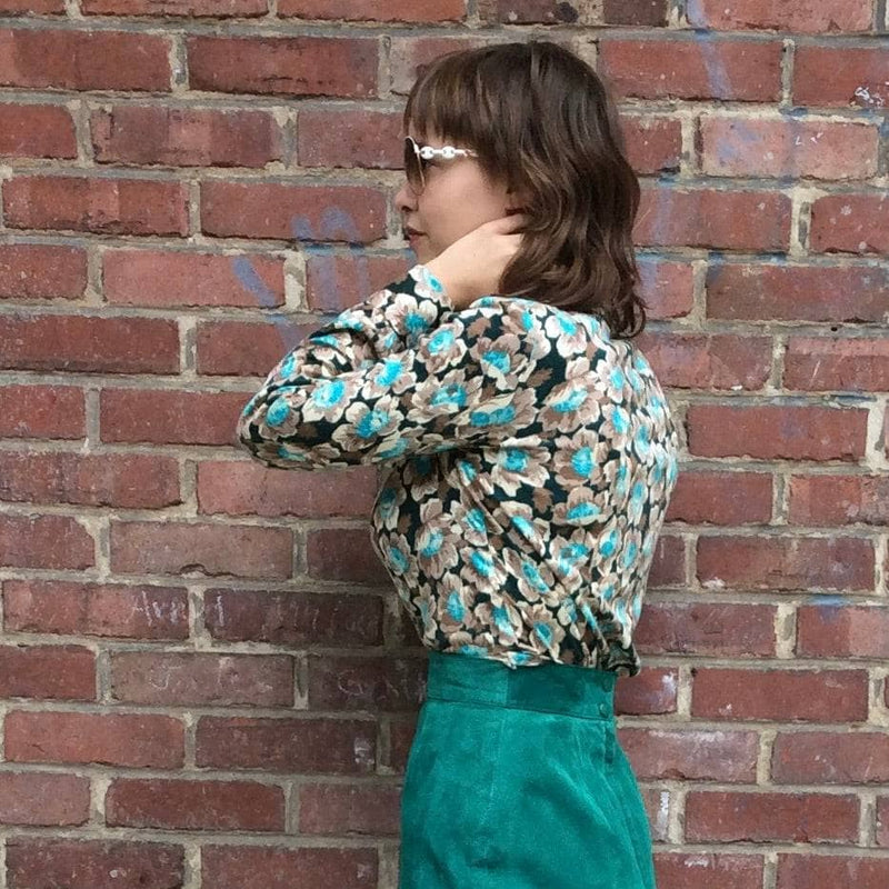 Side view of 1960s-70s Aqua Floral Print Jersey Blouse Size Medium-Large sold by Boheme Vintage Montreal