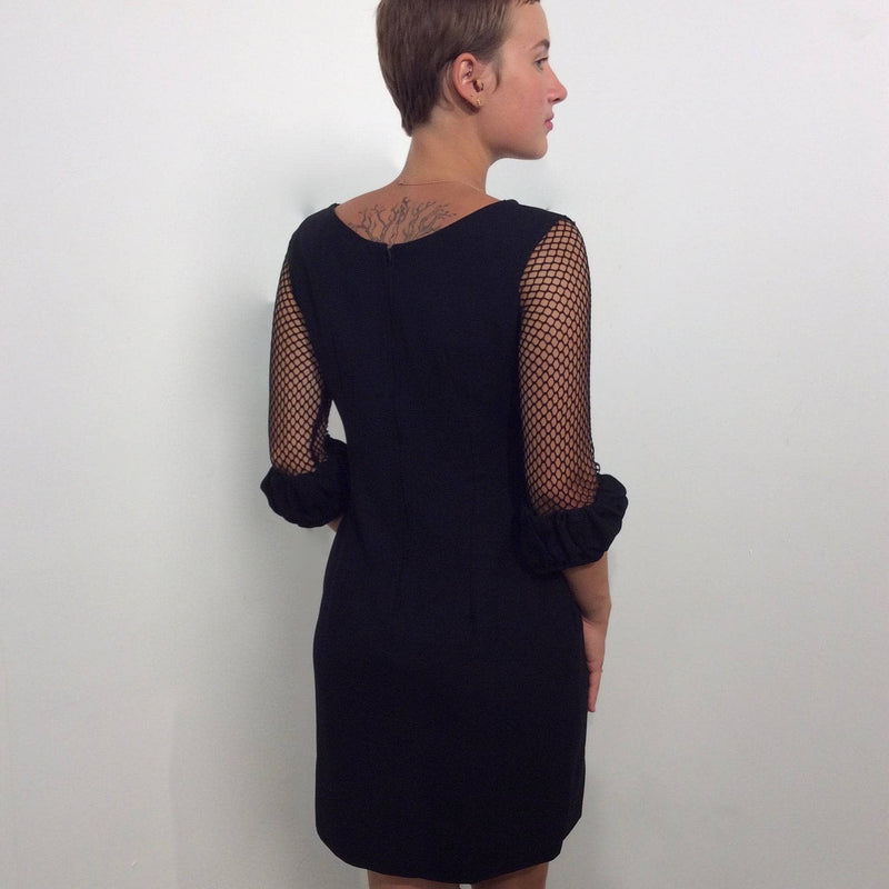 Back view of 1960s Black Mini Shift Dress with Mesh Sleeves size Small sold by bohemevintage.com Montréal