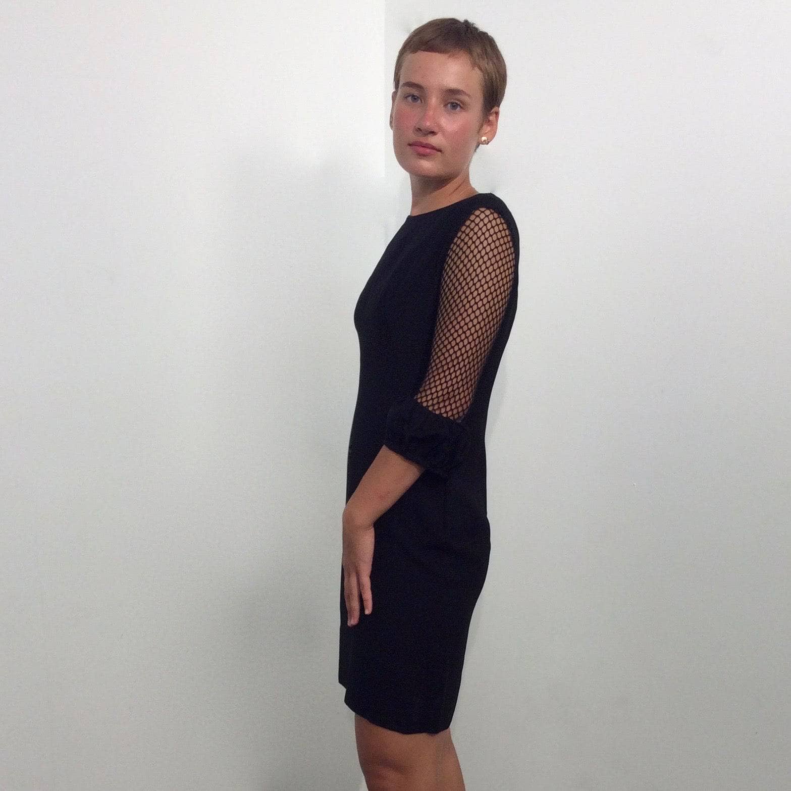 Side view of 1960s Black Mini Shift Dress with Mesh Sleeves size Small sold by bohemevintage.com Montréal