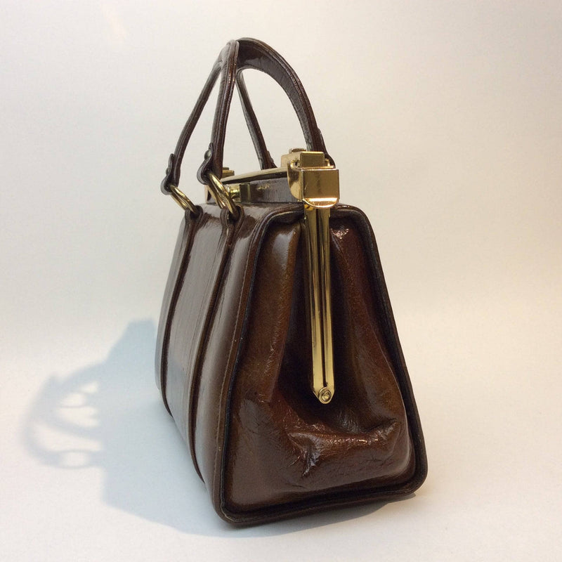 Side view of 1960s Brown Patent Leather Frame Bag with 2 handles from Charisma. sold by bohemevintage.com Montréal